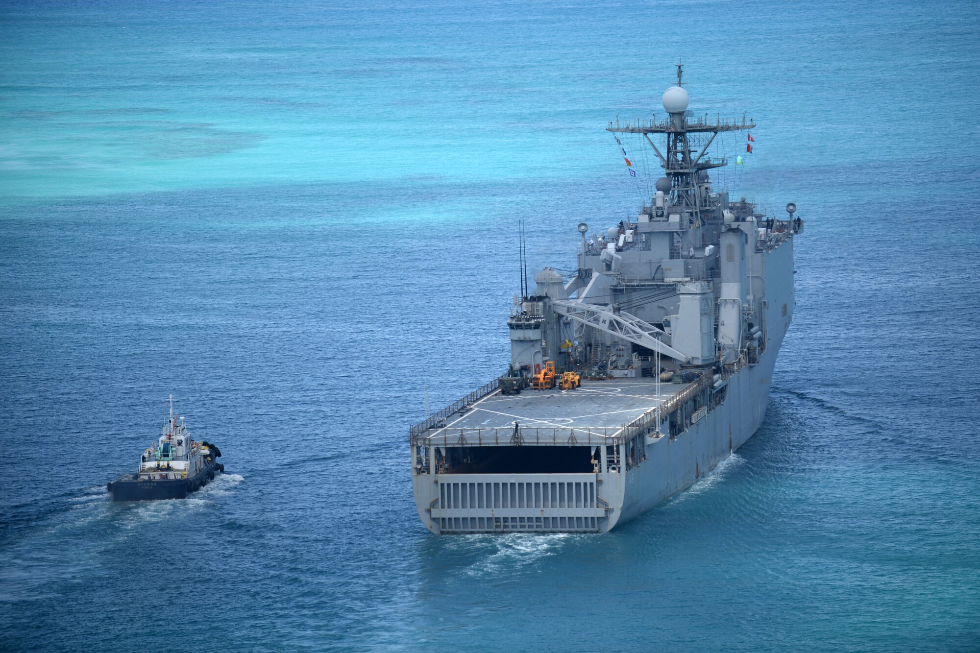 The USS Ashland sails along the coast of Saipan Aug. 9, 2015. The 48 square mile island was battered by Typhoon Soudelor Aug. 2, as the powerful storm made its way across the Pacific. The USS Ashland arrived to the island Aug. 7 to assist in storm recovery efforts. Numerous agencies are contributing to the relief effort including service members from the 36th Contingency Response Group, Helicopter Sea Combat Squadron Two Five and Marine Medium Tiltrotor Squadron 265 (Reinforced), 31st Marine Expeditionary Unit. (U.S. Air Force photo by Senior Airman Joshua Smoot/Released)