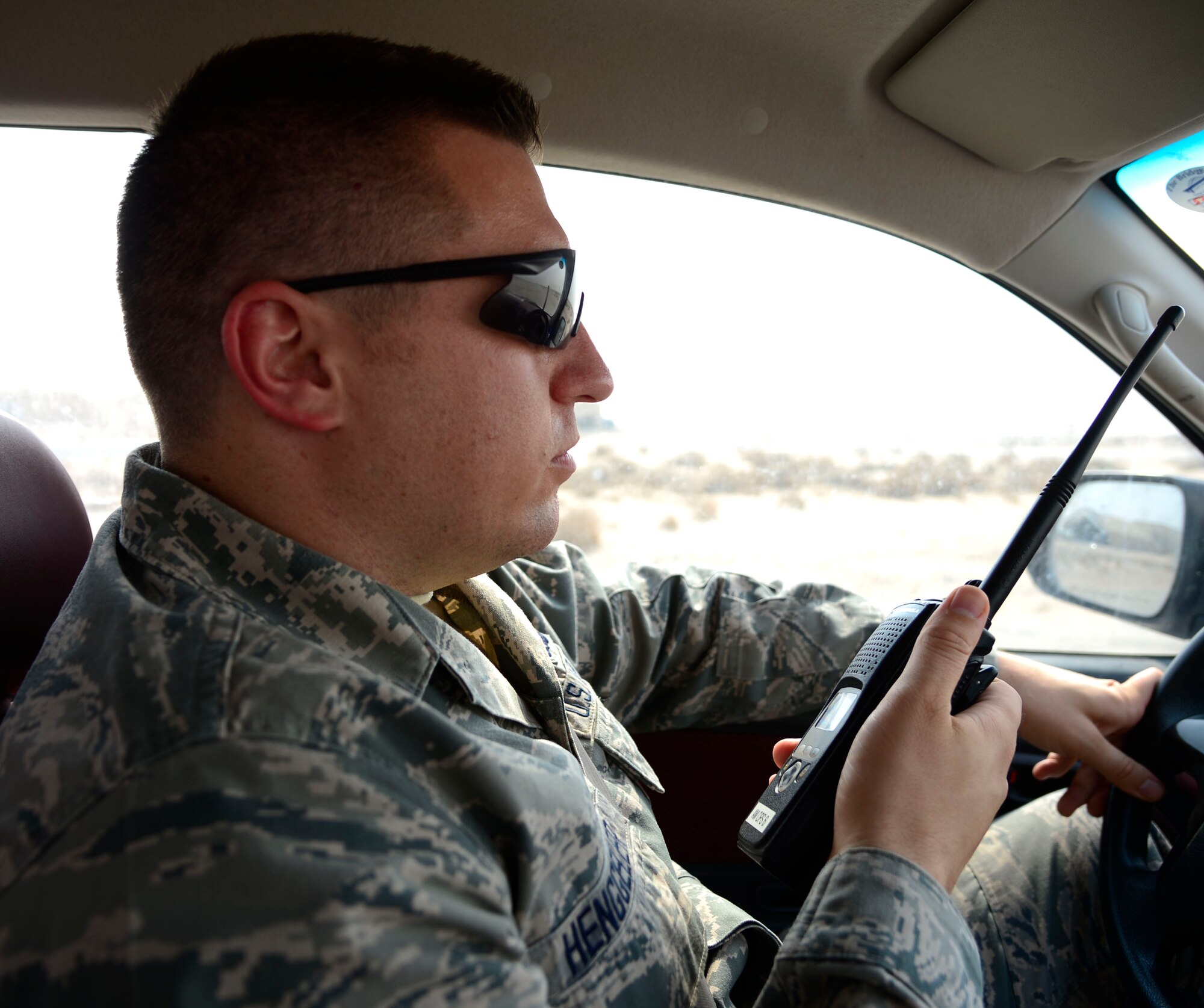 U.S. Air Force Senior Airman Andrew Henggeler, 386 Operations Support Squadron airfield management shift leader, calls to Airmen in the tower during Operation Inherent Resolve at an undisclosed location in Southwest Asia, Aug. 4, 2015. Since August 2014, the Air Force has flown 70 percent of the airstrikes against Da’esh, making airfield management an integral strategic component. (U.S. Air Force photo by Senior Airman Racheal E. Watson/Released)