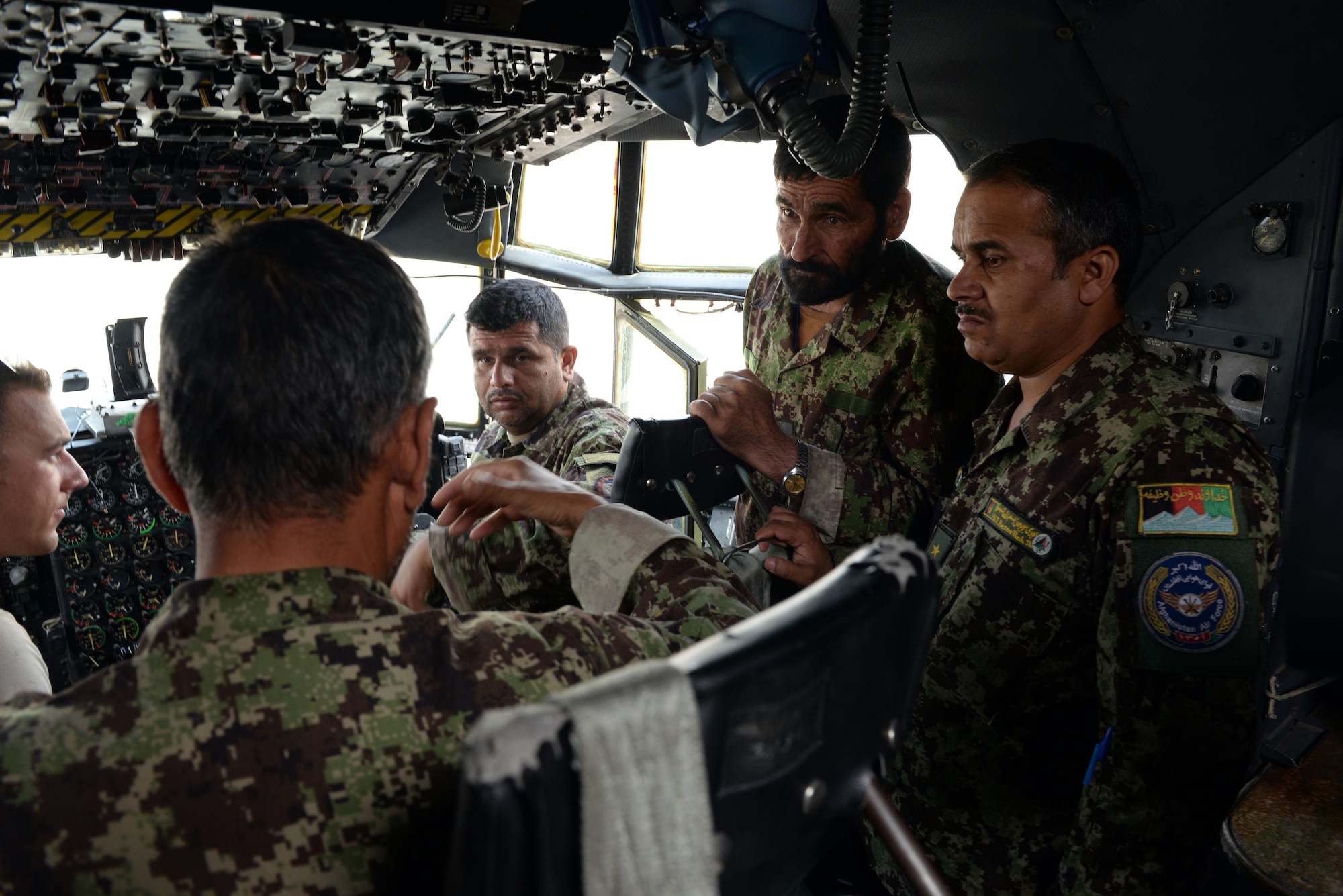 Master Sgt. Antonio Policicchio, 440th Air Expeditionary Advisory Squadron C-130 engine mechanic, discusses engine instrumentation and engine start procedures with Afghan air force mechanics July 28, 2015, at Hamid Karzai International Airport.  Policicchio is deployed to Kabul, Afghanistan, from the 911th Maintenance Squadron in Pittsburgh, Pennsylvania. He is part of the Train, Advise, Assist Command-Air (TAAC-Air) unit that works shoulder-to-shoulder with Afghan partners to develop a professional, capable, and sustainable Air Force.  (U.S. Air Force photo by Senior Airman Cierra Presentado)