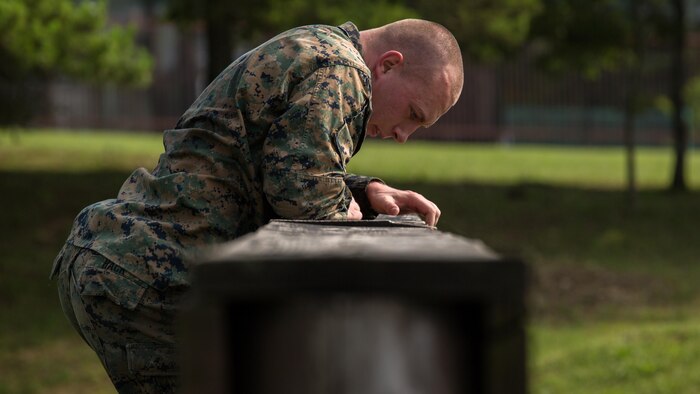 Cpl. Kenneth Hack, a field radio operator with Combat Logistics Company 36, climbs over the high wall during Exercise Dragon Fire 2015 at Combined Arms Training Center Camp Fuji, Japan, July 12. This physical training plays a vital role in developing a combat mindset, which is being prepared for the mental and physical stresses adhered to a combat environment. This annual exercise is used to enhance the service members’ tactical skill sets taught to them in their initial training as well as develop a combat mindset.