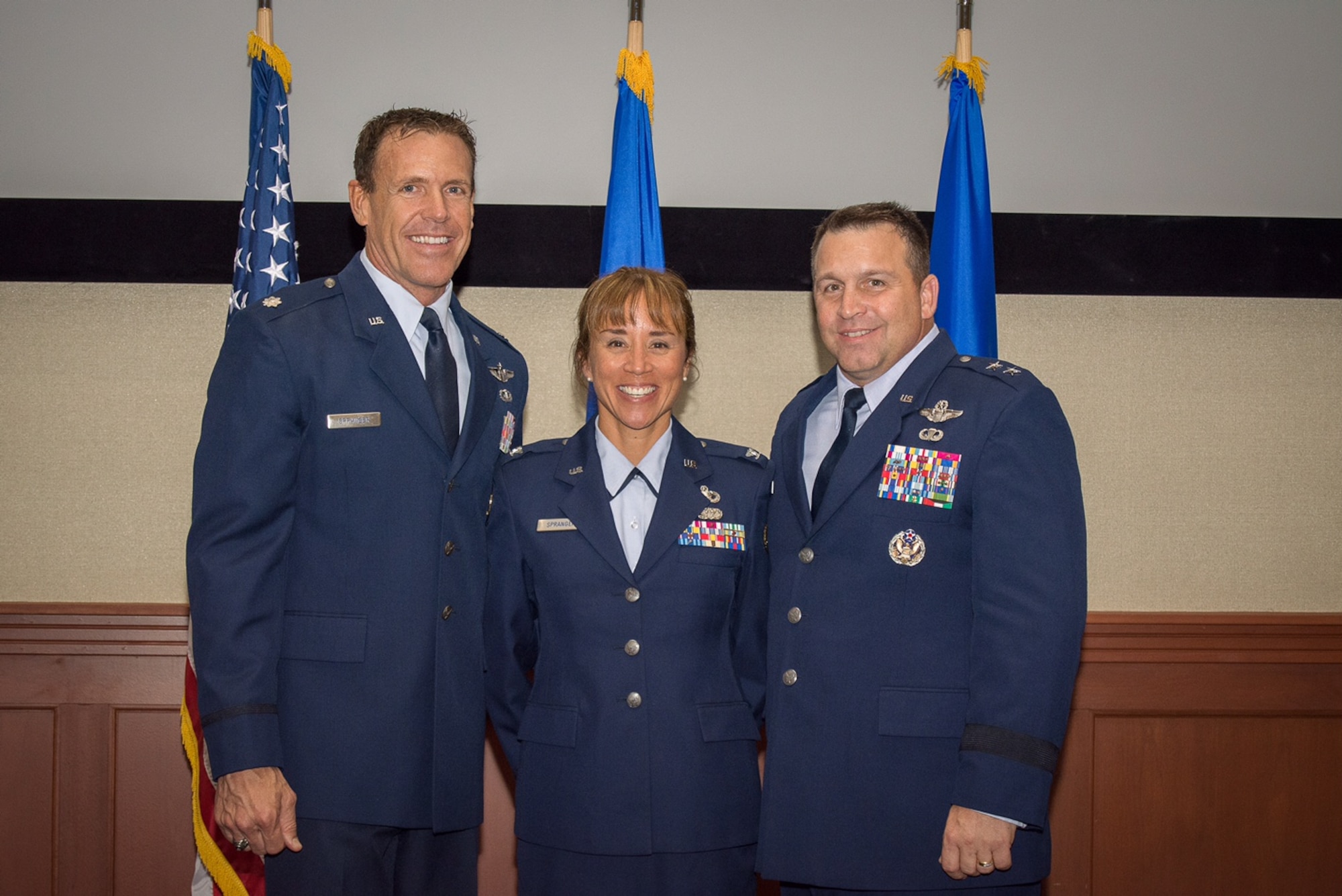 Col. Malia Spranger (center), HQ RIO Detachment 6 commander, and her husband, Lt. Col. Kurt Spranger (left), retired July 17. Maj. Gen Thomas J. Sharpy (right) presided over the ceremony.