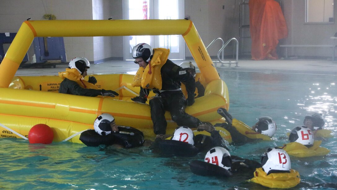 Marines simulated resque protocol during water survival training at Marine Corps Air Station Cherry Point, North Carolina, July 28, 2015. The Aviation Survival Training Center is the only water survival facility on any Marine Corps installation on the East Coast. Naval aviators are given classes on protocol and the gear they use in case of an emergency on an aircraft. The skills they learn in ASTC ensure 2nd Marine Aircraft Wing, its aviators and crew members are qualified and maintain the highest state of readiness.