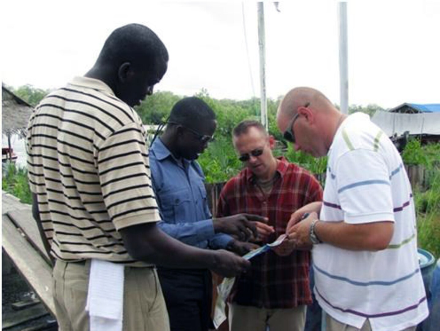 Mr. Mbakhana, a Guyana Defense Force sailor, along with Missouri National Guard Soldier’s Capt. Aaron Larimore, and Staff Sgt. Michael Blomberg review river routes and communication short falls with the Guyana Defense Force’s current equipment.