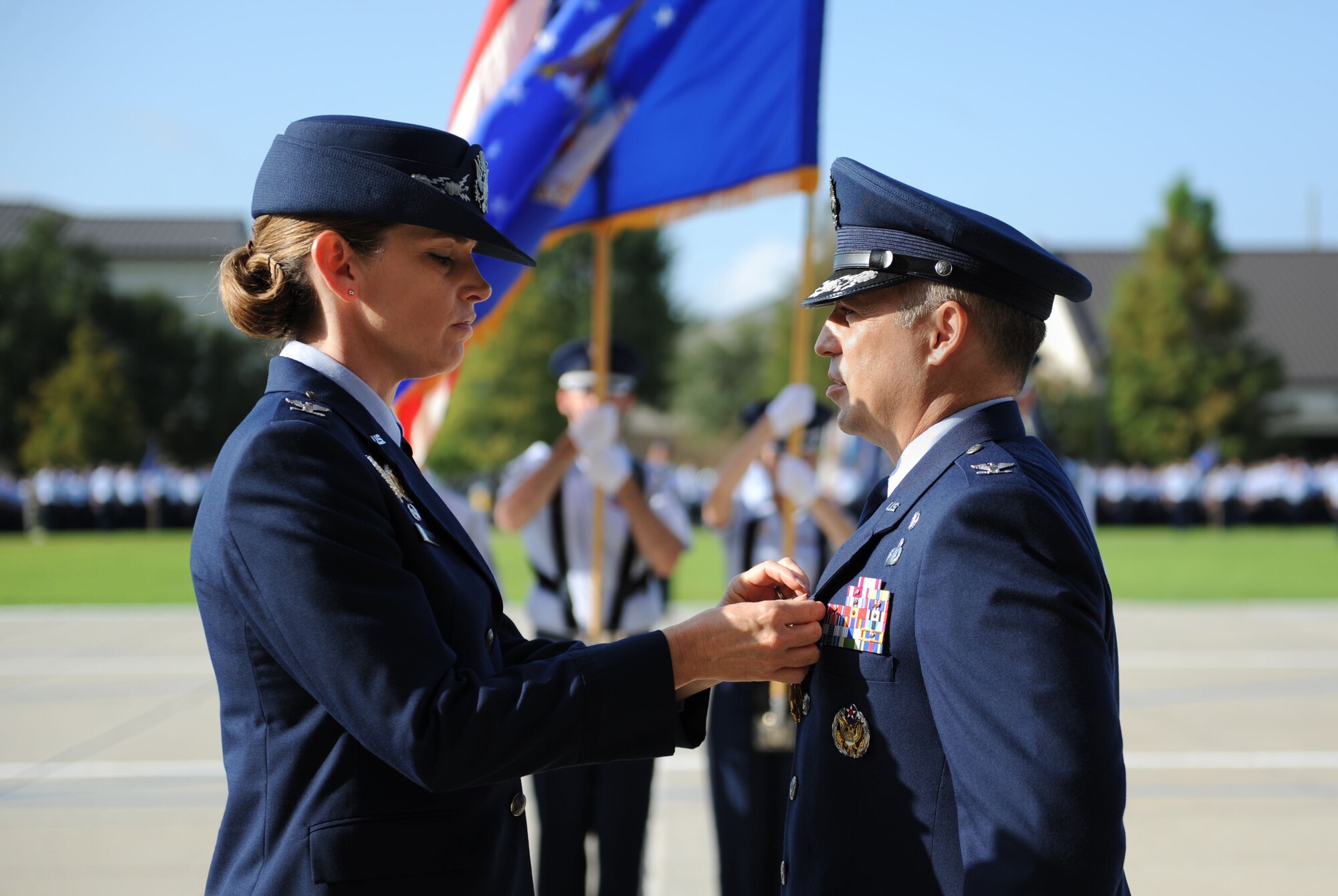Col. Michele Edmondson, 81st Training Wing commander, presents the Legion of Merit medal to Col. George Tombe, outgoing 81st Training Group commander, during a change of command ceremony, August 7, 2015, Keesler Air Force Base, Miss.  Col. Tombe has been selected to serve as the financial management and comptroller director at Headquarters USAFE-AFAFRICA. (U.S. Air Force photo by Kemberly Groue)