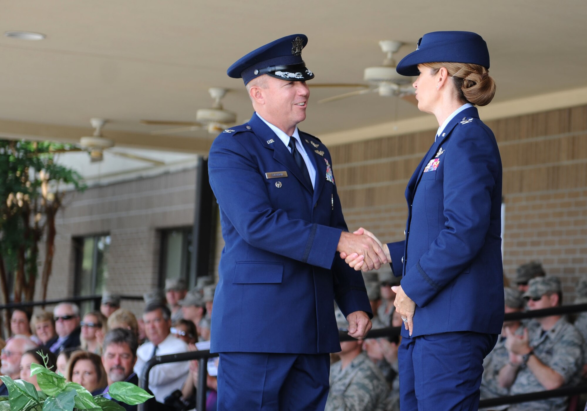 Col. Scott Solomon, 81st Training Group commander, is congratulated by Col. Michele Edmondson, 81st Training Wing commander, during a change of command ceremony, August 7, 2015, Keesler Air Force Base, Miss.  Edmondson was the officiating officer for the ceremony. (U.S. Air Force photo by Kemberly Groue)