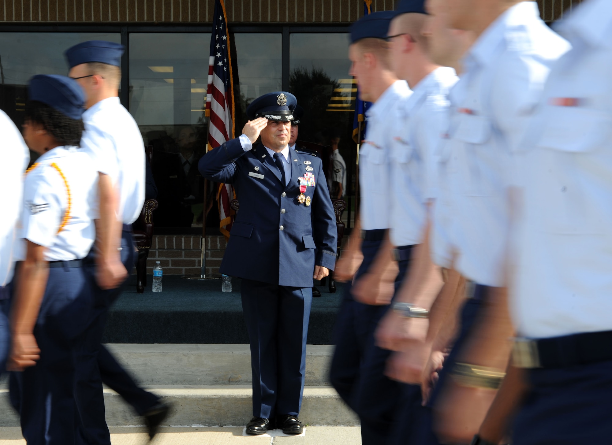 Col. George Tombe, outgoing 81st Training Group commander, renders a salute to Airmen as they pass in formation during a change of command ceremony, August 7, 2015, Keesler Air Force Base, Miss. Tombe has been selected to serve as the financial management and comptroller director at Headquarters USAFE-AFAFRICA. (U.S. Air Force photo by Kemberly Groue) 