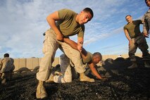 Marines with 1st Marine Regiment, 1st Marine Division, practice take down techniques on an early morning at Camp Wilson aboard Marine Corps Ground Air Combat Center Twentynine Palms, Calif., Aug. 7, 2015. While the Marines are here for various training exercises, they use their limited off time to improve themselves in the Marine Corps Martial Arts Program and ensure they are prepared for anything that may come their way.