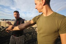 Marines with 1st Marine Regiment, 1st Marine Division, practice disarming enemy combatants on an early morning at Camp Wilson aboard Marine Corps Ground Air Combat Center Twentynine Palms, Calif., Aug. 7, 2015. While the Marines are here for various training exercises, they use their limited off time to improve themselves in the Marine Corps Martial Arts Program and ensure they are prepared for anything that may come their way.
