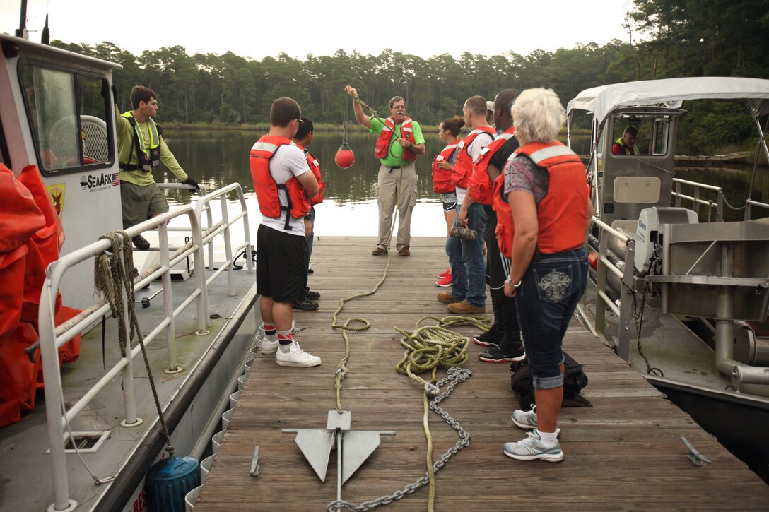 Charles Herron instructs trainees during a facility response training exercise conducted to ensure top performance in the possible situation of an oil spillage at Marine Corps Air Station Cherry Point, North Carolina, Aug. 4, 2015. Typically referred to as Open Water Spill Team Training, the annual training is mandatory under federal and state laws such as the Clean Water Act and the Oil Pollution Act of 1990. Spill response measures are put into place to provide control, containment and cleanup in order to prevent injury and damage to personnel, property, and the environment.