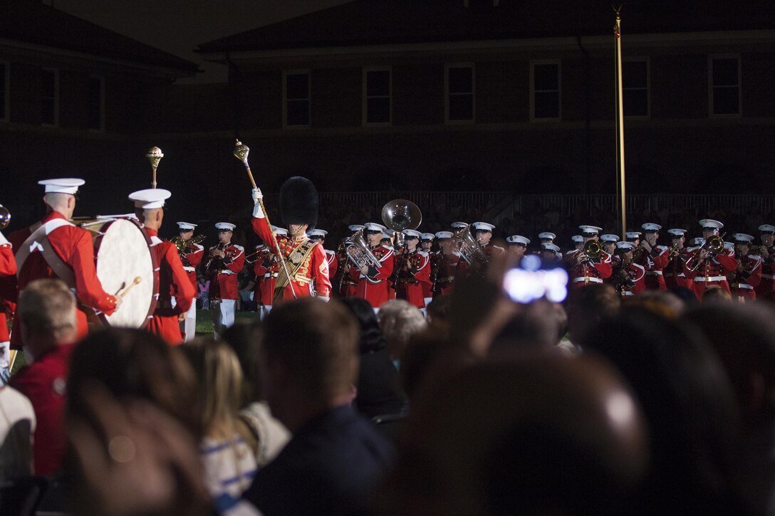 The U.S. Marine Band performs during an evening parade at Marine Barracks Washington, D.C., Aug. 7, 2015. The Honorable George P. Shultz, the 60th United States Secretary of State., was the guest of honor for the parade, and U.S. Marine Corps Gen. Joseph F. Dunford, 36th commandant of the Marine Corps, was the hosting official. The Evening Parade began in 1934 and features the Silent Drill Platoon, the U.S. Marine Band, the U.S. Marine Corps Drum and Bugle Corps, and two marching companies. More than 3500 guests attend the parade every week. (U.S. Marine Corps photo by Lance Cpl. Kayla V. McTaw/Released)