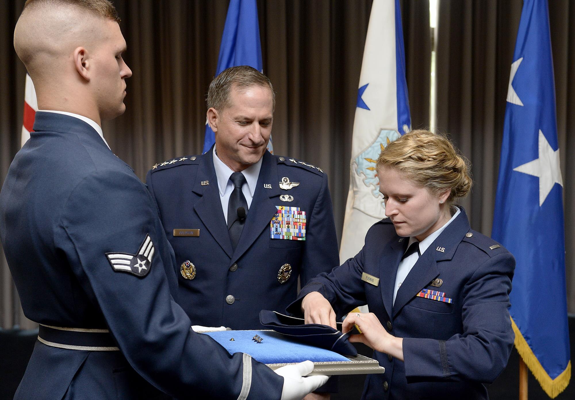 The rank of general is pinned on David L. Goldfein's flight cap by his daughter, 1st Lt. Danielle Fleming, during his promotion ceremony Aug. 6, 2015, in Washington, D.C. Goldfein's promotion makes him the Air Force's 38th vice chief of staff.  (U.S. Air Force photo/Scott M. Ash)