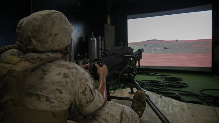 A Marine with Weapons Company, 2nd Battalion, 2nd Marine Regiment, fires on virtual targets with a Mk 19 automatic grenade launcher during training at the Indoor Simulated Marksmanship Trainer at Marine Corps Base Camp Lejeune, N.C., Aug. 5, 2015. The ISMT allows training with a variety of simulated weapons including Mk 19s, M2 50-caliber machine guns, M240 medium machine guns and M16 service rifles. 