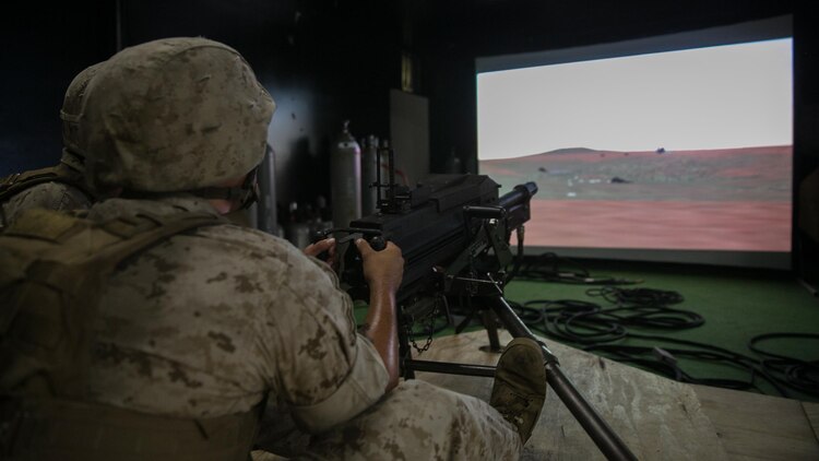 A Marine with Weapons Company, 2nd Battalion, 2nd Marine Regiment, fires on virtual targets with a Mk 19 automatic grenade launcher during training at the Indoor Simulated Marksmanship Trainer at Marine Corps Base Camp Lejeune, N.C., Aug. 5, 2015. The ISMT allows training with a variety of simulated weapons including Mk 19s, M2 50-caliber machine guns, M240 medium machine guns and M16 service rifles. 