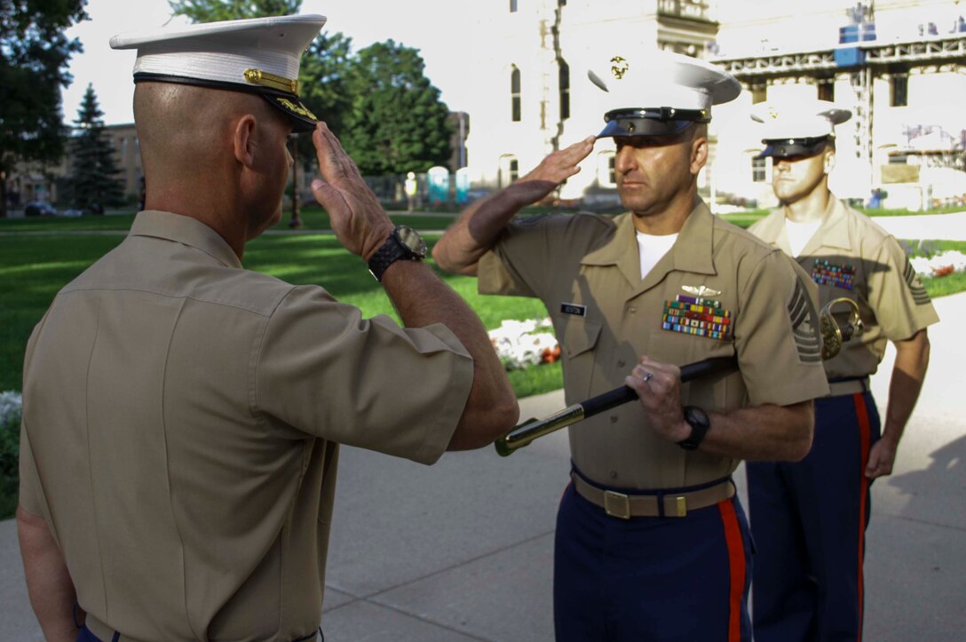 Sgt. Maj. Benny Benton, middle, relinquished his post as Recruiting Station Lansing sergeant major to Sgt. Maj. Kevin Bowman, right, during a relief and appointment ceremony upon the lawn of the Lansing, Mich., capitol building, July 19, 2015. Bowman said he is confident he has the ability to lead RS Lansing and the recruiters now under his charge, though it will be tough to fill Benton’s shoes.