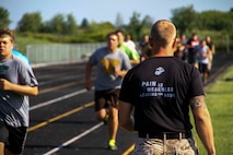 Staff Sgt. Luke DeJong, staff non-commissioned officer in charge of Recruiting Sub Station Saginaw, Mich., motivates Bay City Western High School’s football team during a Combat Fitness Test, July 23, 2015. DeJong said the CFT is meant to instill the warrior ethos into the football team to bring them together as a family much like the Marine Corps.