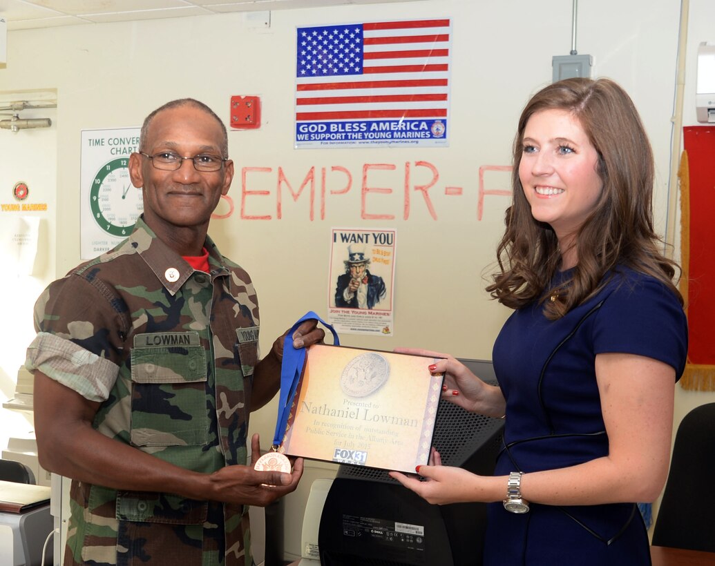 Retired Marine Corps Master Sgt. Nathaniel Lowman receives the Thomas Jefferson Community Service Award from Tracey Smith, news anchor/reporter, Fox 31 News, Albany, Ga. The award was presented to Lowman for his work with the Young Marines of Albany and in the community during a ceremony held at the Young Marines of Albany headquarters, Marine Corps Logistics Base Albany, Aug. 5.
