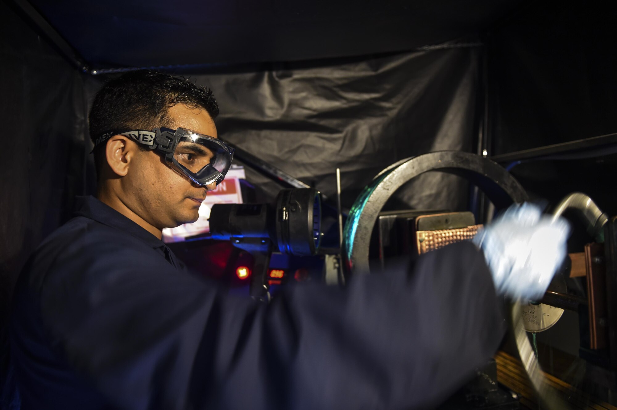 Airman 1st Class Raju Subedi, 1st Special Operations Equipment Maintenance Squadron non-destructive inspection apprentice, inspects a test object on Hurlburt Field, Fla., July 21, 2015. The NDI flight is responsible for detecting the smallest imperfections, wear and cracks on aircraft as well as aerospace ground equipment. (U.S. Air Force photo/Senior Airman Christopher Callaway)