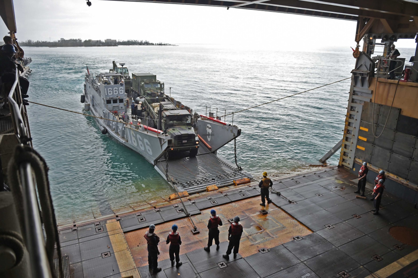 SAIPAN HARBOR, Saipan (August 8, 2015) - Vehicles from the 31st Marine Expeditionary Unit (MEU) are unloaded from the well deck of the amphibious dock landing ship USS Ashland (LSD 48) via Landing Craft Utility vehicle during disaster relief efforts in Saipan after Typhoon Soudelor made landfall. Ashland is assigned to the Bonhomme Richard Expeditionary Strike Group and is on patrol in the U.S. 7th Fleet area of operations. 