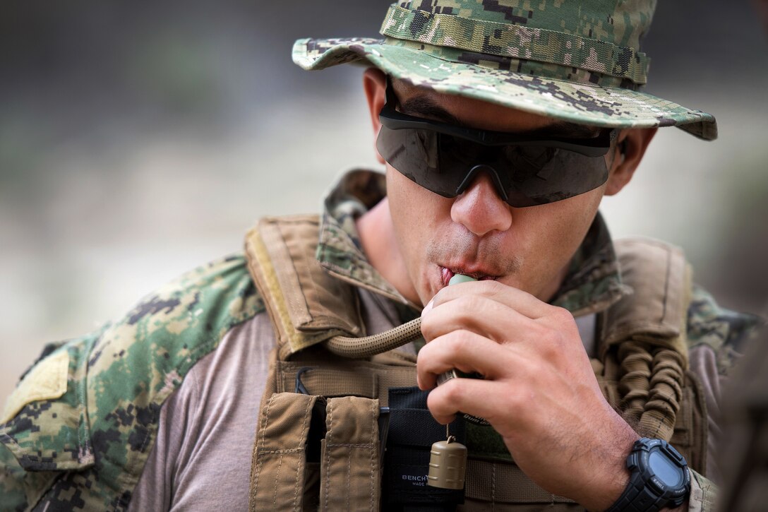 U.S. Navy Petty Officer 2nd Class Anthony Martinez drinks water during Fleet Combat Camera Pacific’s Summer Quick Shot 2015 combined joint field training exercise in the Angeles National Forest near Azusa, Calif., Aug. 3, 2015. Martinez is assigned to Expeditionary Combat Camera. U.S. Army, Navy, Marine Corps, Air Force and Canadian combat cameraman are participating in Quick Shot, a semi-annual exercise that improves COMCAM service members' abilities to operate in a tactical environment.