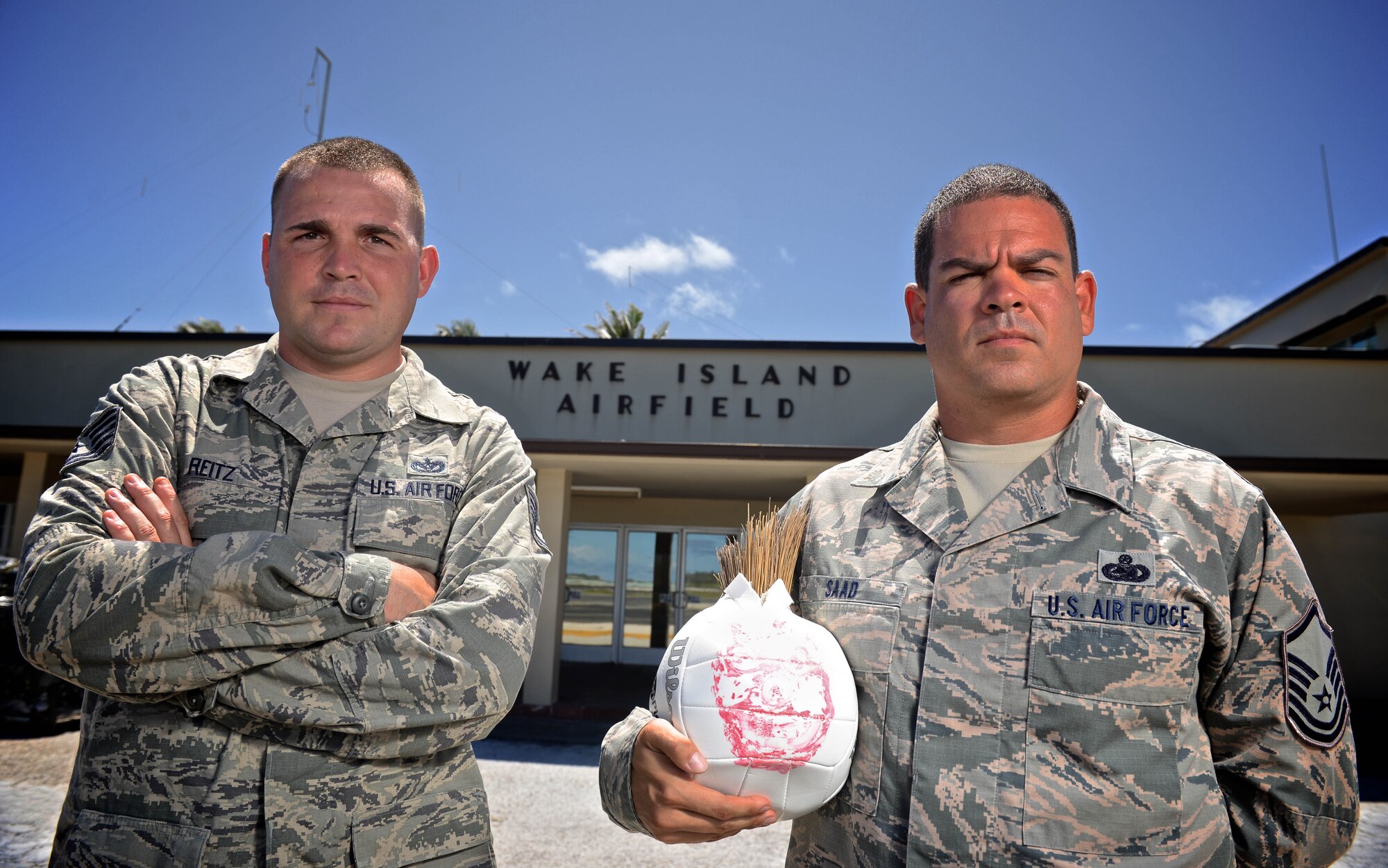 Tech. Sgt. Joshua Reitz, left, and Master Sgt. Yusef Saad, both contracting representatives with Detachment 1, PACAF Regional Support Center, stand in front of the passenger terminal at Wake Island Airfield, July 21, 2015. A small team with four Airmen of Det. 1 supervises contractor operations and ensures mission success on the remote atoll in the Pacific. (U.S. Air Force photo by Staff Sgt. Alexander W. Riedel/Released)