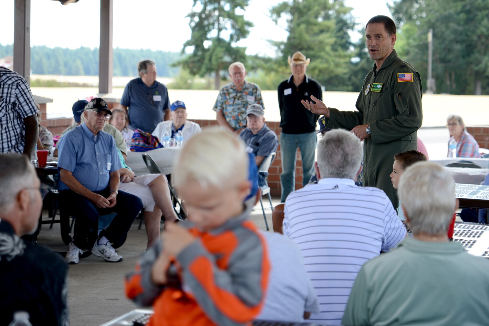 Col. Ethan Griffin, 62nd Airlift Wing vice commander, speaks to members from the 62nd Troop Carrier Wing, 62nd Airlift Wing Association, and McChord Air Museum Aug. 8, 2015, at Joint Base Lewis-McChord, Wash. During their visit to McChord Field, the reunion members traveled between Heritage Hill and the McChord Air Museum hangar to look at the aircrafts here and were able to explore some of them such as a C-141 Starlifter and C-130 Hercules. (U.S. Air Force photo/Airman 1st Class Keoni Chavarria)