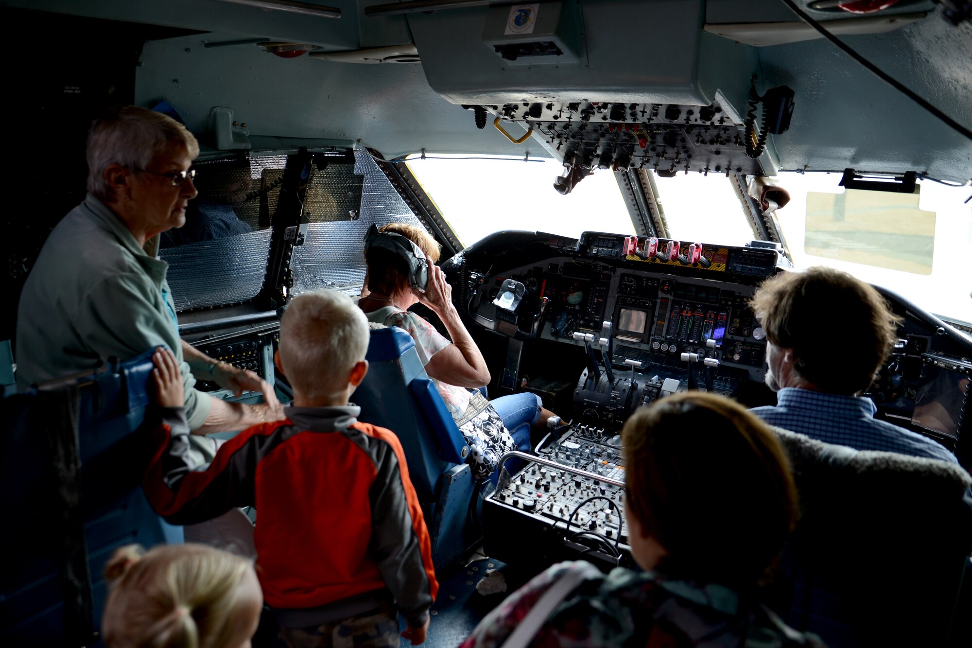 Members from the 62nd Troop Carrier Wing, 62nd Airlift Wing Association, and McChord Air Museum, look at the flight deck of a C-141 Starlifter Aug. 8, 2015, at Joint Base Lewis-McChord, Wash. Members of the 62nd TCW had a picnic at Heritage Hill during their visit to McChord Field, where they presented an award to McChord Air Museum volunteers for their dedication. (U.S. Air Force photo/Airman 1st Class Keoni Chavarria)