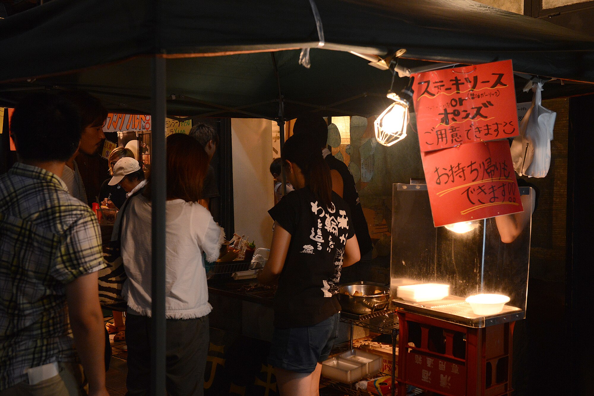 Vendors serve traditional Japanese fair food during the Tanabata Festival in Fussa City, Japan, Aug. 7, 2015. Yakisoba (fried noodles), yakitori (kebabs), takoyaki (octopus balls) and kakigore (shaved ice) were sold to Japanese and U.S. parade attendees. (U.S. Air Force photo by Senior Airman David C. Danford/Released)