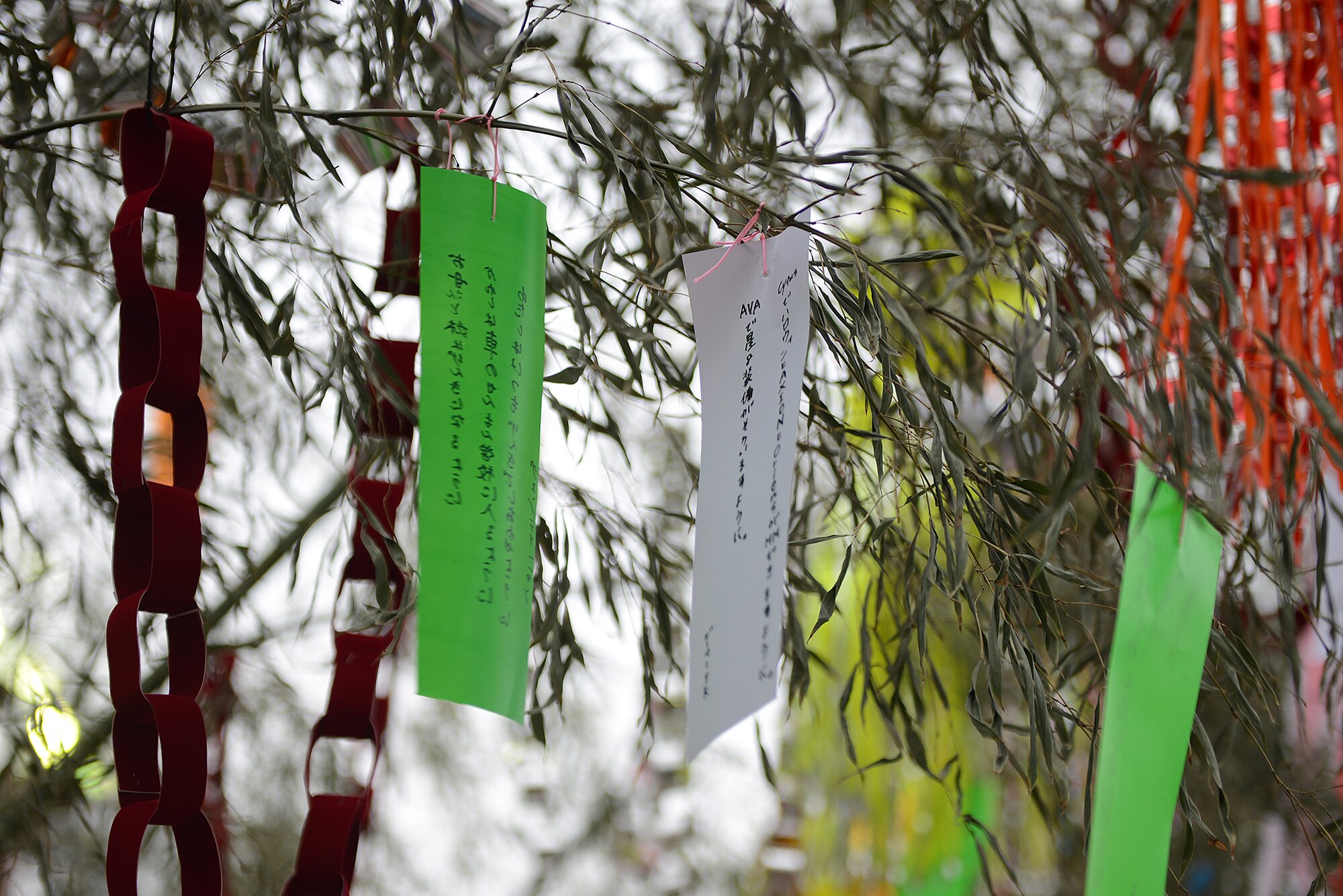 Local residents hang tanzaku, or wish-slips, from a bamboo tree during the Tanabata Festival in Fussa City, Japan, Aug. 7, 2015. Tanabata is one of Japan’s five seasonal festivals. (U.S. Air Force photo by Senior Airman David C. Danford/Released)