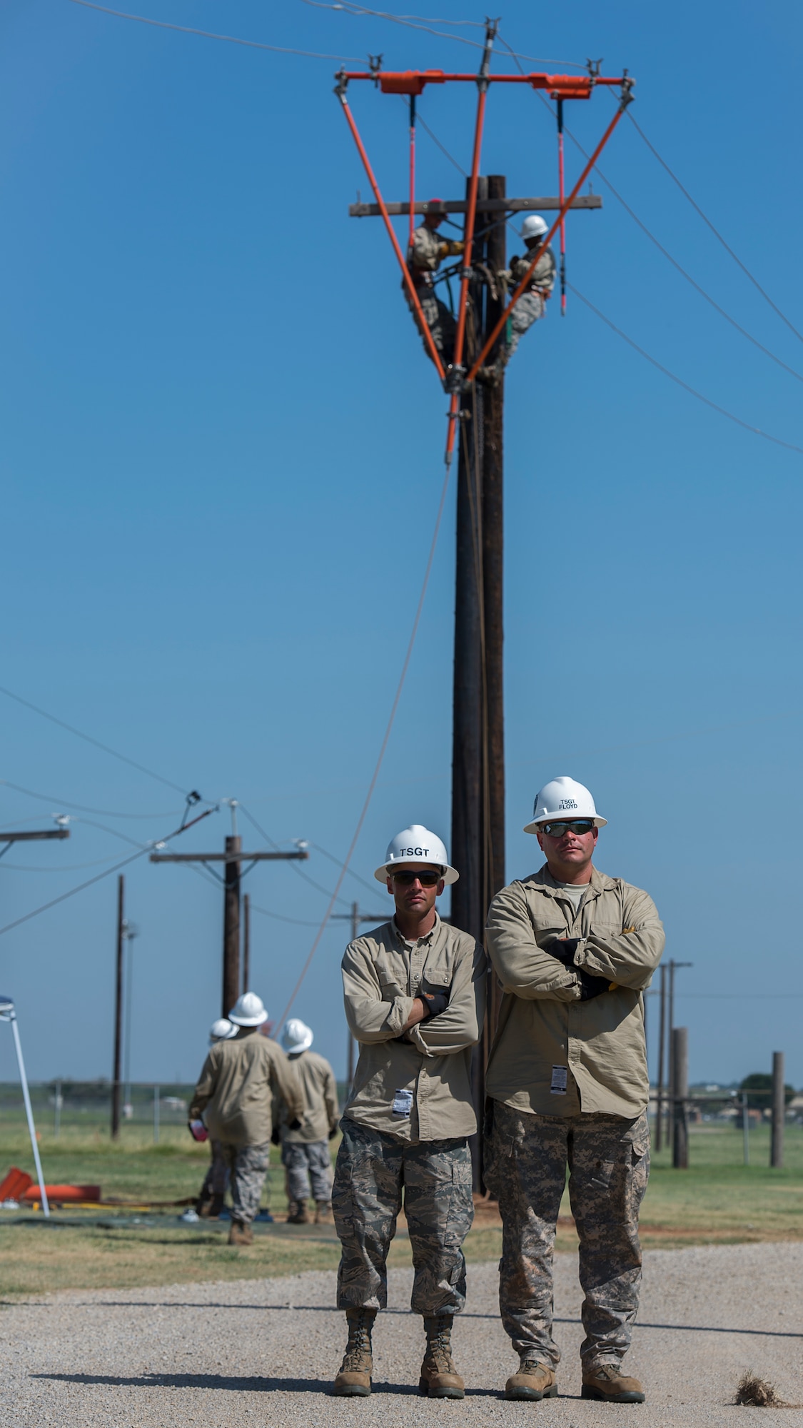 U.S. Air Force Tech. Sgt. Rocky Edwards Knode, (left), 366th Training Squadron instructor and native of Honolulu Hawaii, stand beside U.S. Air Force Tech. Sgt. Trevor Floyd, (right), 366th Training Squadron instructor in training and native of Kansas City Mo., during their Hotline Training Course at Sheppard Air Force Base, Texas, Aug. 7, 2015. Edwards Knode helped in the validation process for the new Hotline Training Course material. He also helped train Floyd to be the new instructor for the course. Airmen in this course wear a modified uniform to protect themselves from the various equipment and chemicals they use. (U.S. Air Force photo by Senior Airman Kyle Gese/Released)