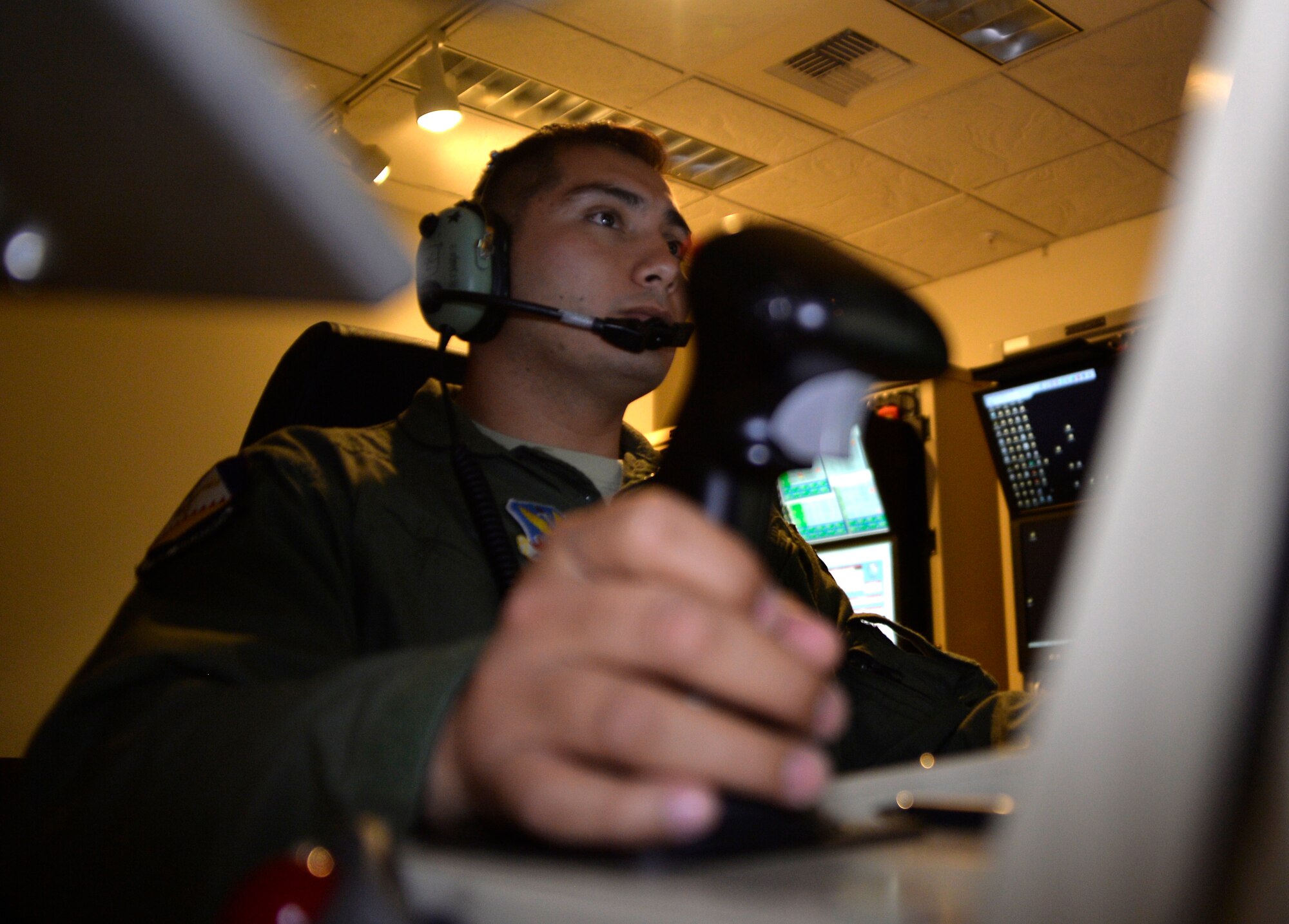 Staff Sgt. Mario, 42nd Attack Squadron sensor operator, flies a test mission as part of the 2015 Air-Ground Weapons Systems Evaluation Program Combat Hammer exercise, Aug. 5, 2015, at Creech Air Force Base, Nevada. The aircrew was evaluated on the timeliness, accuracy, and precision of employing munitions from remotely piloted aircraft. (U.S. Air Force photo by Airman 1st Class Christian Clausen/Released)
