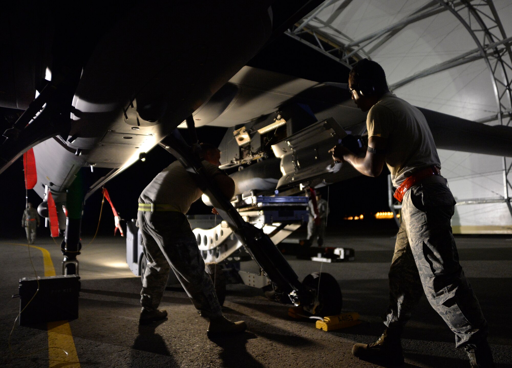 Airmen from the 432nd Aircraft Maintenance Squadron load a GBU-12 Paveway II laser-guided bomb on an MQ-0 Reaper Aug. 5, 2015, at Creech Air Force Base, Nevada. The maintenance crew was evaluated on timeliness, safety, and precision of loading munitions on remotely piloted aircraft as part of the 2015 Air-Ground Weapons Systems Evaluation Program also known as Combat Hammer. (U.S. Air Force photo by Airman 1st Class Christian Clausen/Released)

