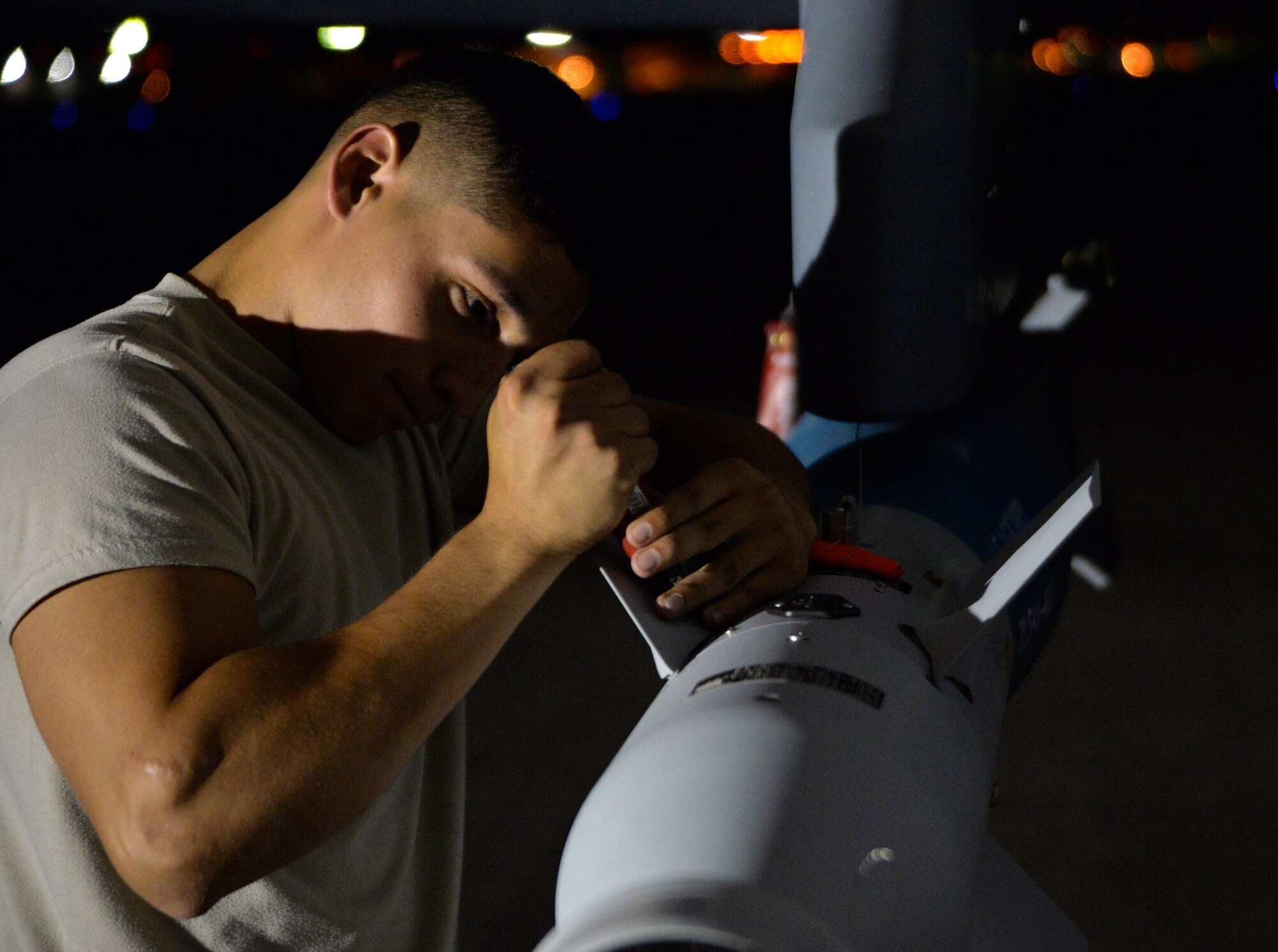 Airman 1st Class Ricardo Garcia, 432nd Aircraft Maintenance Squadron weapons load crew member assembles a GBU-12 Paveway II laser guided bomb Aug. 5, 2015, at Creech Air Force Base, Nevada. The weapons load was part of the 2015 Air-Ground Weapons Systems Evaluation Program exercise. (U.S. Air Force photo by Airman 1st Class Christian Clausen/Released)
