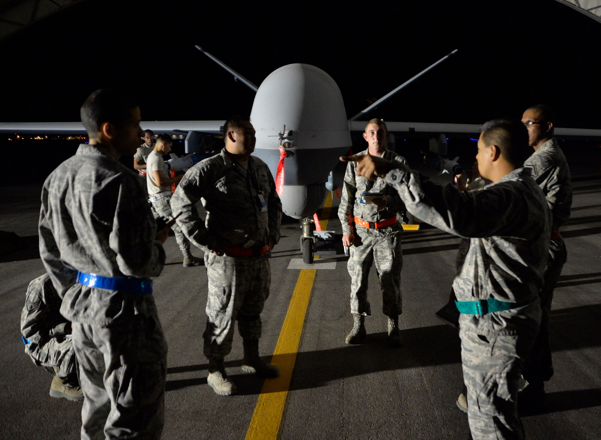 Evaluators from the Air-Ground Weapons Systems Evaluation Program discuss the ongoing WSEP exercise Aug. 5, 2015, at Creech Air Force Base, Nevada. The exercise took place Aug. 3-7 and tested maintenance, pilot, sensor operator, and intelligence crews to ensure precision of remotely piloted aircraft strikes. (U.S. Air Force photo by Airman 1st Class Christian Clausen/Released)

