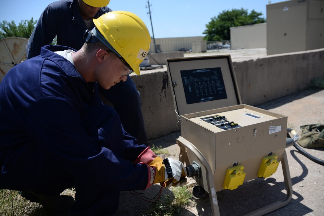 Airman 1st Class David Higgins and Airman Ricardo Alvarez, 366th Training Squadron electrical systems students, test for continuity on a primary distribution panel with a multimeter tool. Students learn how to perform troubleshooting exercises to prepare for any problem. Upon completion of training, both Higgins and Alvarez will head to Joint Base McGuire-Dix-Lakehurst, N.J., where their skills as electricians could potentially be put to the test during the upcoming hurricane season. (U.S. Air Force photo by Senior Airman Robert L. McIlrath)