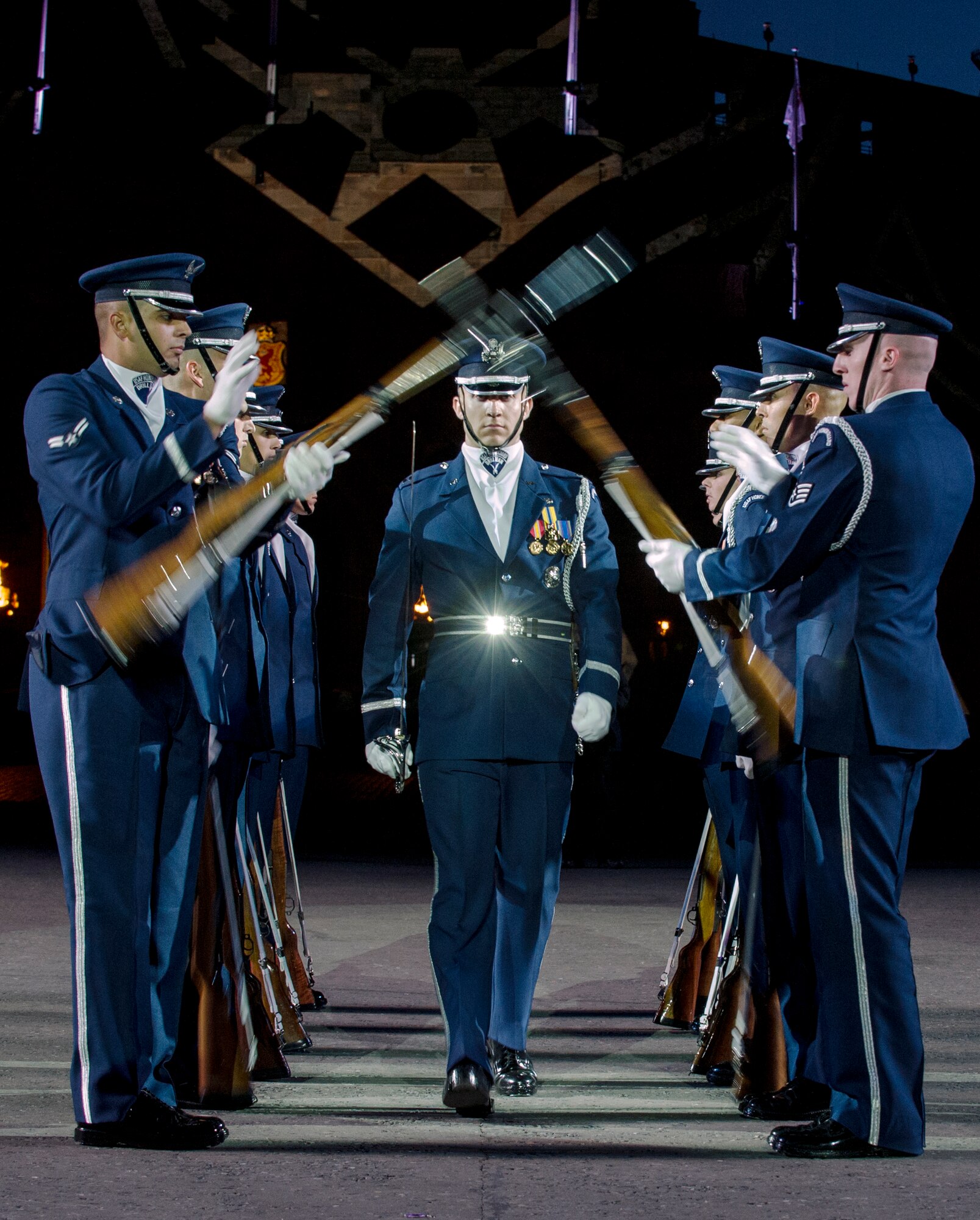 The United States Air Force Honor Guard Drill Team performs the walkthrough during The Royal Edinburgh Military Tattoo on the Esplanade of the Edinburgh Castle in Edinburgh, Scotland Aug. 6, 2015. This is the 66th production of the tattoo and it welcomes more than 220,000 spectators from around the world for more than 3 weeks. (U.S. Air Force photo/Staff Sgt. Nichelle Anderson/Released)