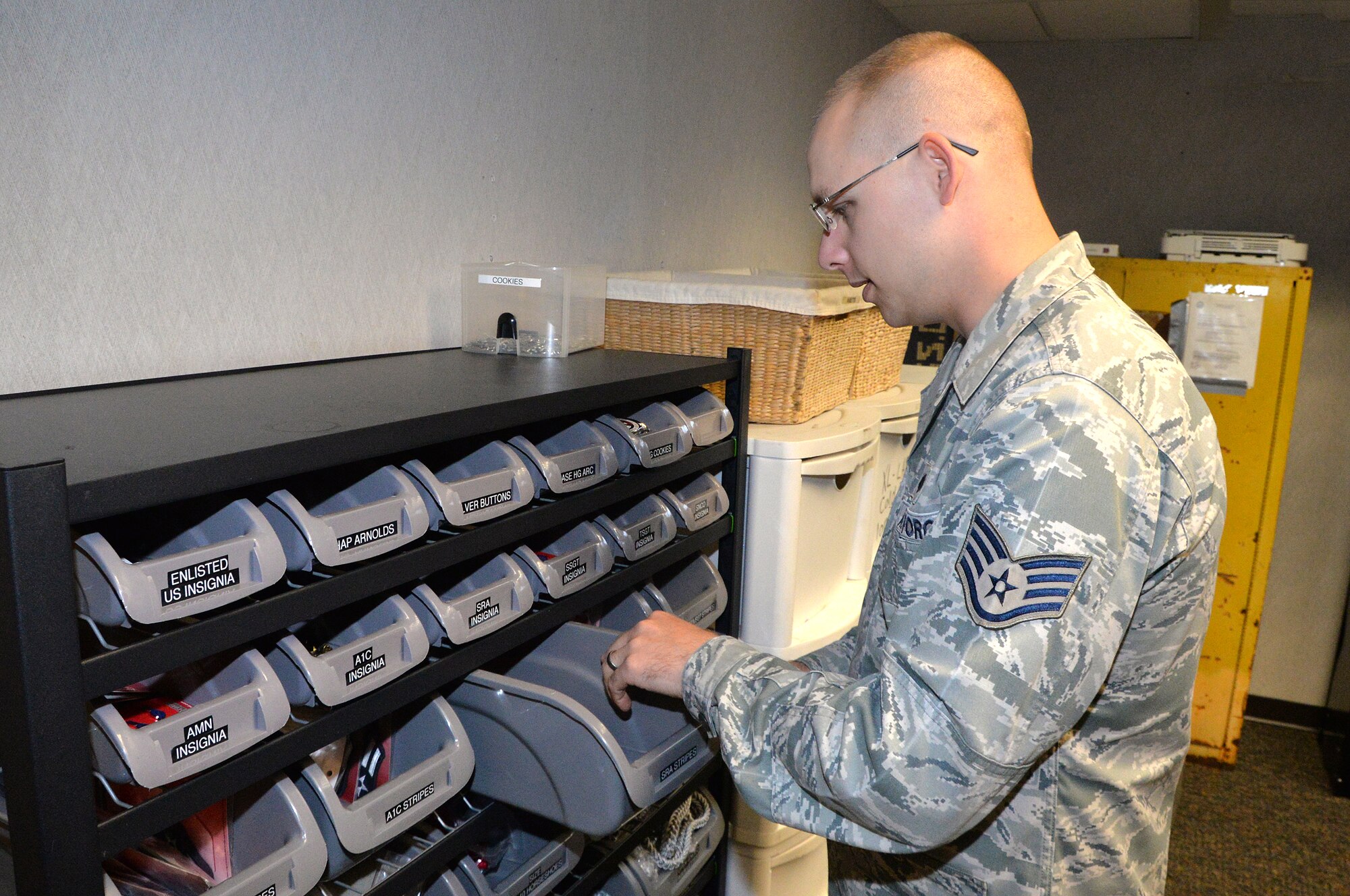 U.S. Air Force Staff Sgt. Christopher Burke’s, 55th Wing Honor Guard NCO in charge, organizes drawers full of uniform items such as rank insignia and stripes Aug. 7 at Offutt Air Force Base, Nebraska. Burke has collected more than 300 various items needed to equip and outfit the honor guard members. (U.S. Air Force photo by Dana P. Heard)