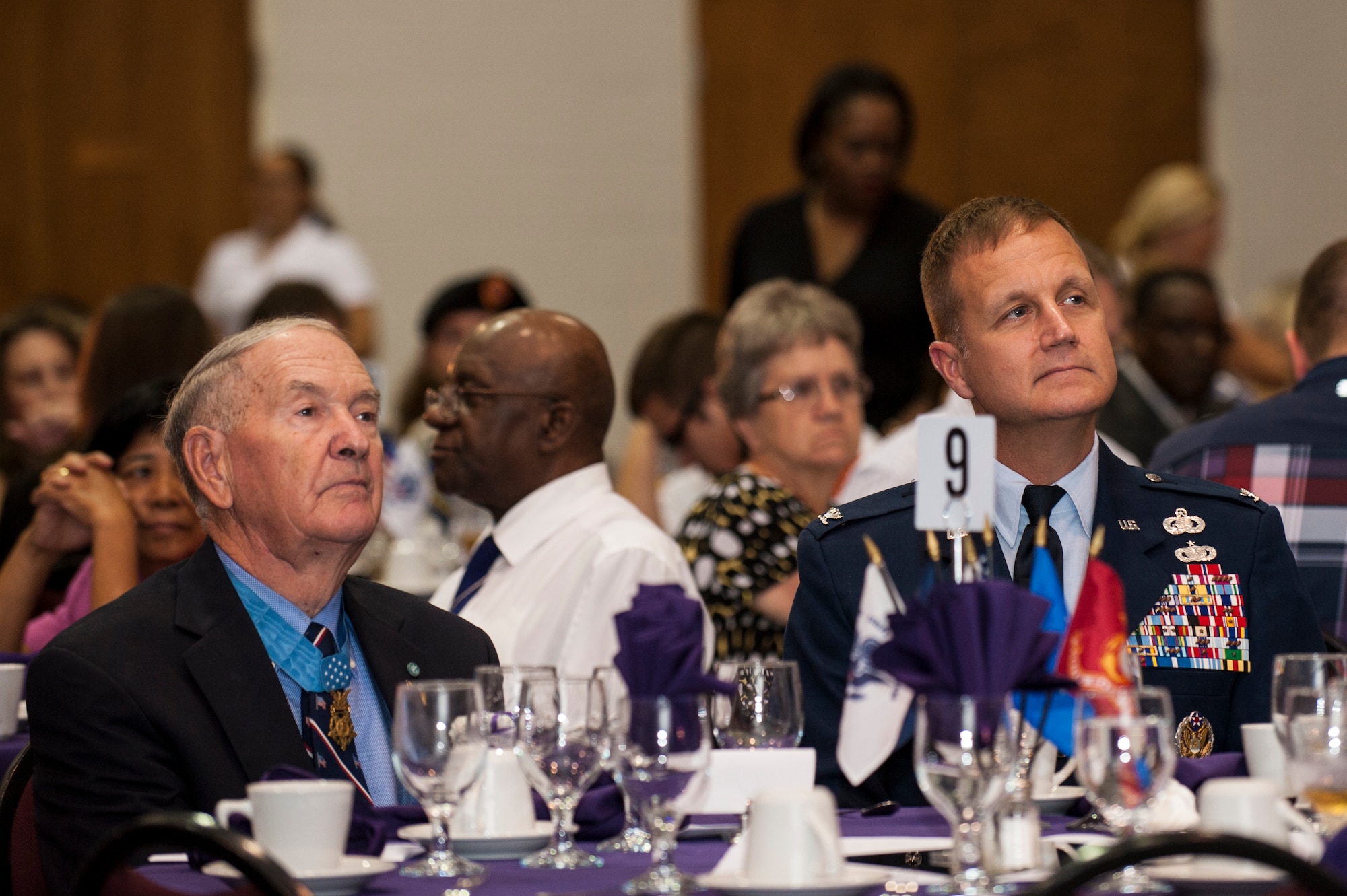 Retired U.S. Army Col. Walter Marm (left) sits with Col. Joe Slavick, 4th Mission Support Group commander, during the 4th Annual Purple Heart Banquet, Aug. 7, 2015, at the First Pentecostal Holiness Church in Goldsboro, North Carolina. The banquet recognized 50 military veterans who’ve received the Purple Heart Medal, representing every major conflict since World War II. (U.S. Air Force photo/Airman Shawna L. Keyes)
