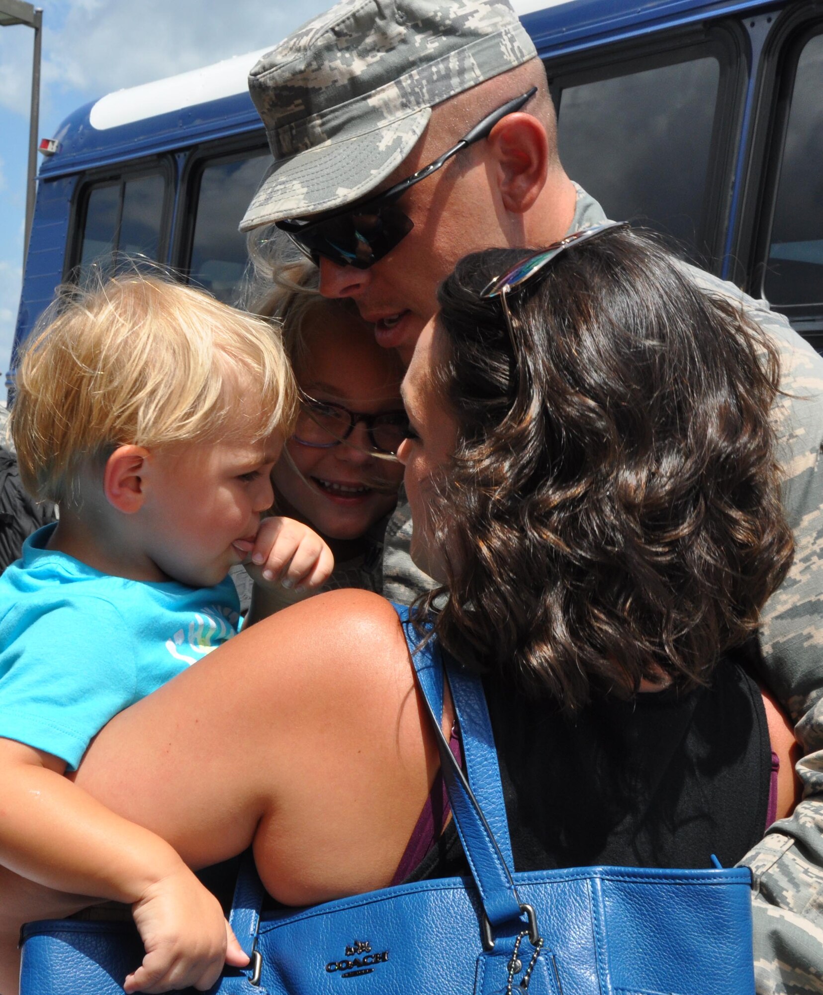 Senior Airman Derek McLaren, 931st Aircraft Maintenance Squadron maintainer, greets his spouse, Natalie, and his two children Aug. 10, 2015, at McConnell Air Force Base, Kan. Approximately ten members of the 931st Air Refueling Group returned after a deployment to Southwest Asia. (U.S. Air Force photo by Tech. Sgt. Abigail Klein