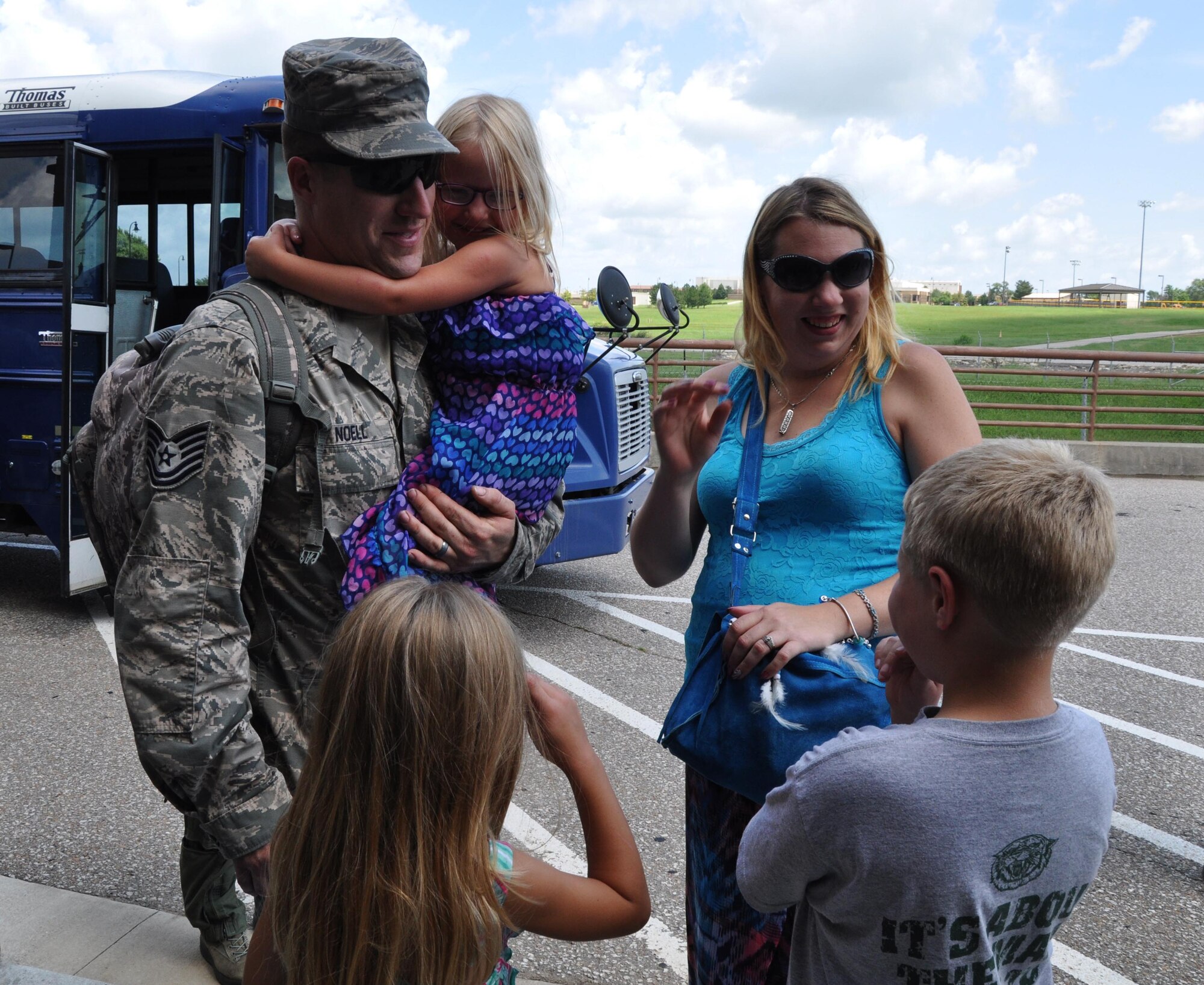Tech. Sgt. John Noell, 931st Aircraft Maintenance Squadron maintainer, greets his spouse, Brandy, and his three children after returning from a recent deployment to Southwest Asia Aug. 10, 2015, at McConnell Air Force Base, Kan. During his deployment, Noell and nine other members of the 931st Air Refueling Group performed aircraft maintenance and filled other support roles. (U.S. Air Force photo by Tech. Sgt. Abigail Klein)