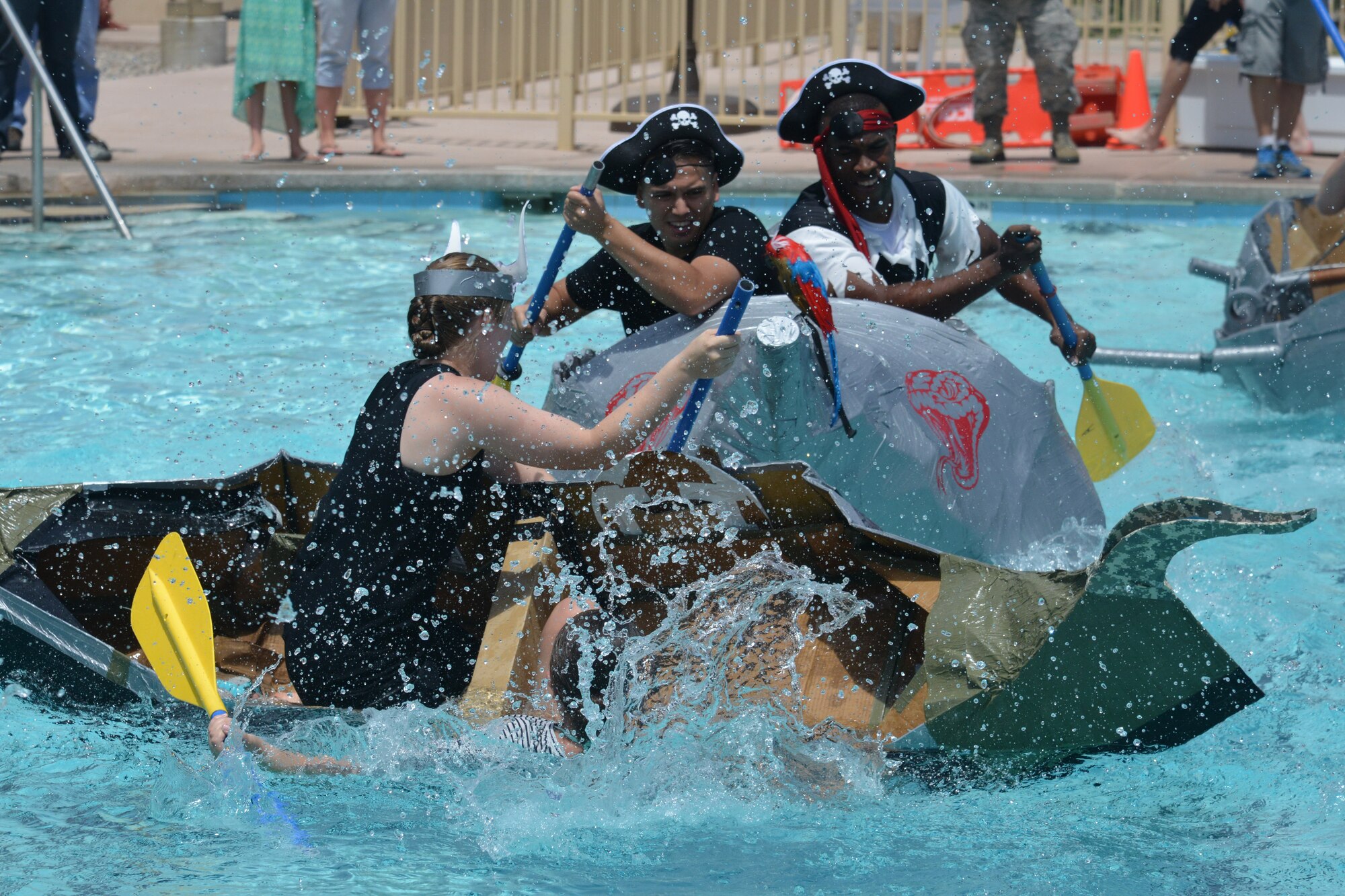 Eighteen teams competed in Kirtland's annual Battle of the Battleships Aug. 7 at the Mountain View Club pool. Teams raced boats made only of cardboard and duct tape. (Photo by Ken Moore)