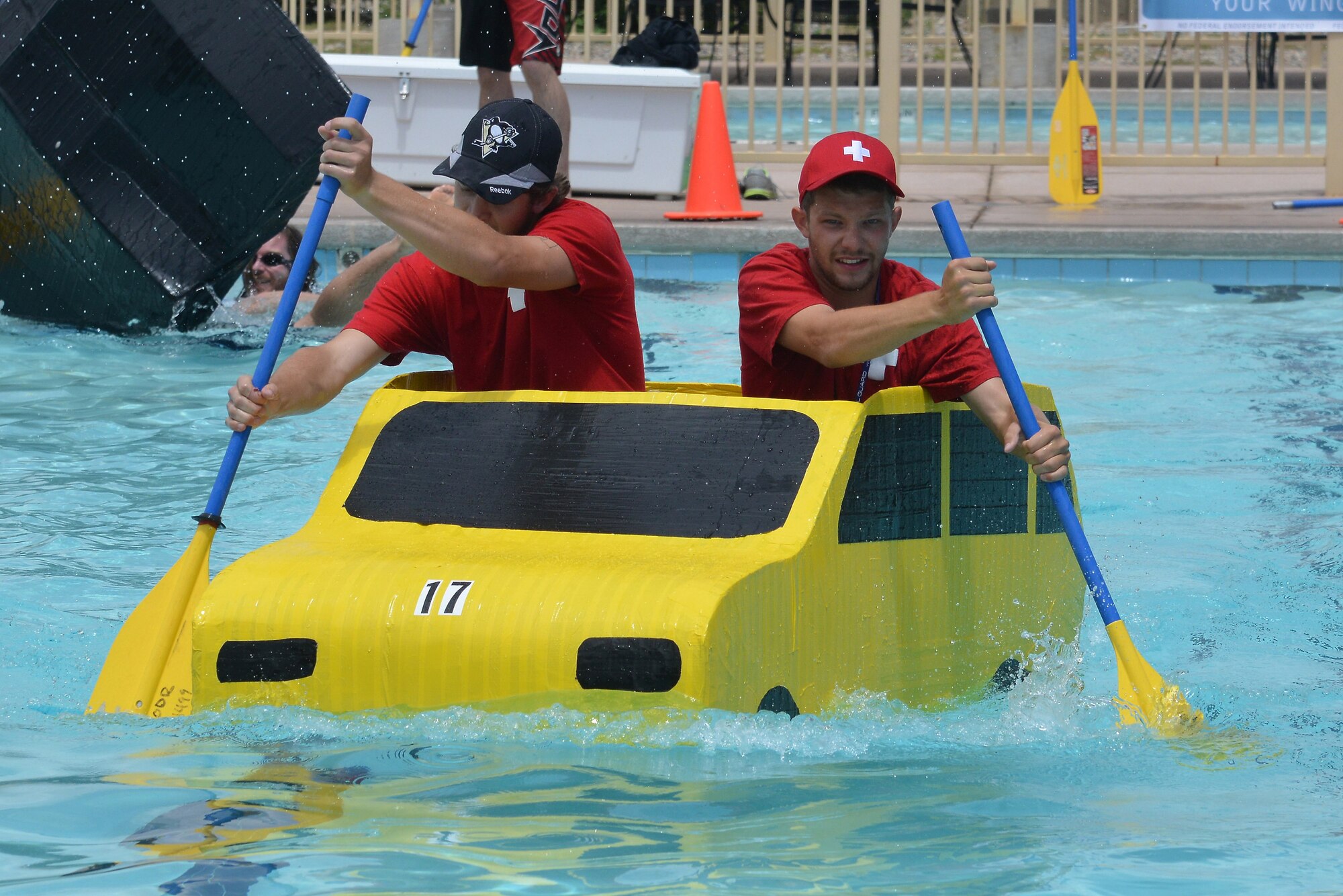 Eighteen teams competed in Kirtland's annual Battle of the Battleships Aug 7 at the Mountain View Club pool.  Teams raced boats made only of cardboard and duct tape. (Photo by Ken Moore)