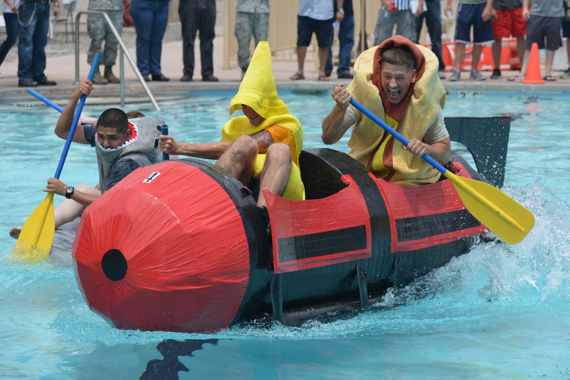 Eighteen teams competed in Kirtland's annual Battle of the Battleships Aug 7 at the Mountain View Club pool.  Teams raced boats made only of cardboard and duct tape. (Photo by Ken Moore)