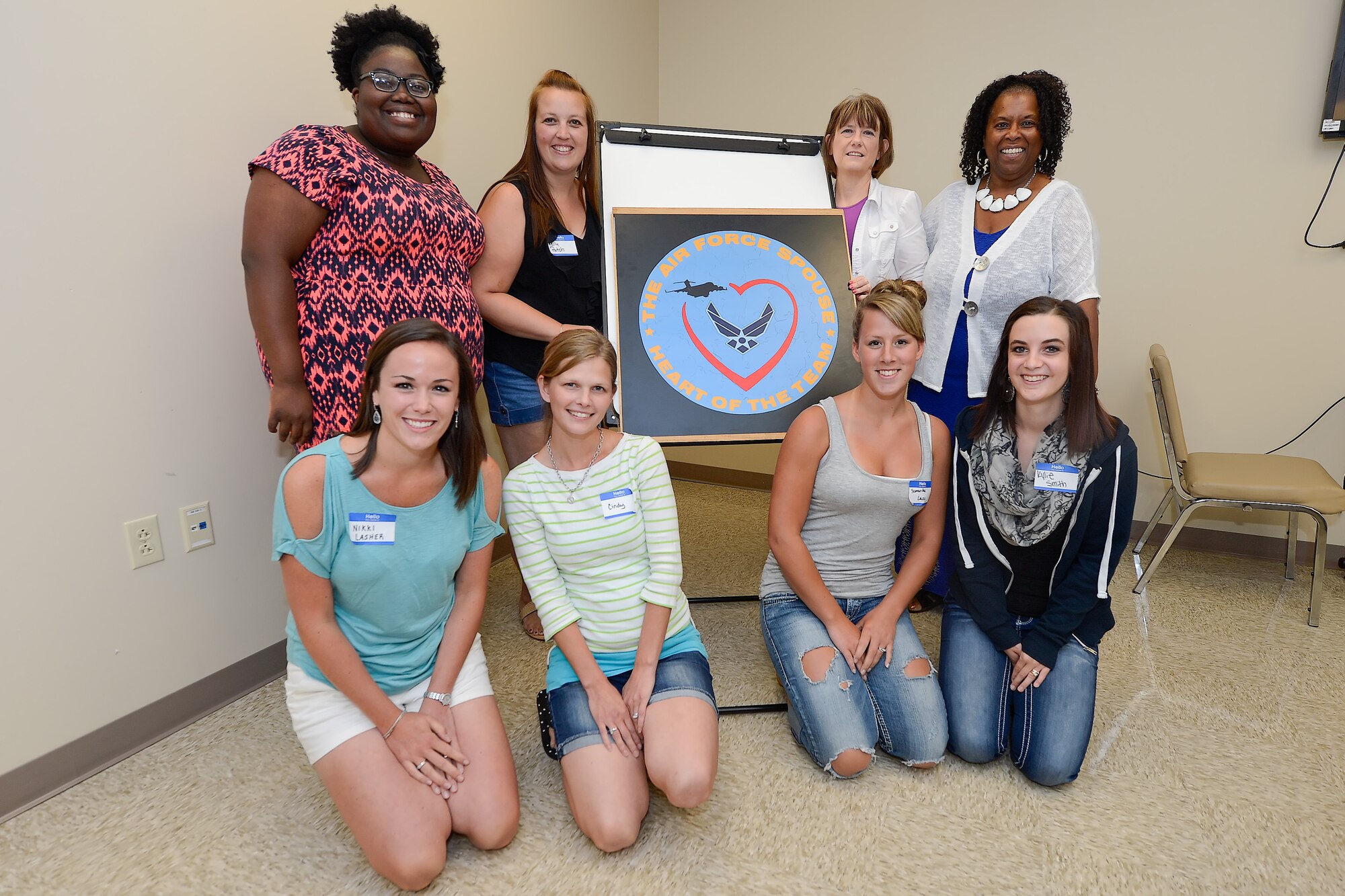 Team Dover spouses and mentors pose with a puzzle they have completed together during Dover's Heart Link, a spouse orientation class sponsored by the Airman and Family Readiness Center and the Air Force Aid Society, July 30, 2015 at Dover Air Force Base, Del. The class included briefings on military pay and benefits, housing options and gave the group a chance to make friends and team-build through sponsored activities. (U.S. Air Force photo/Greg L. Davis)