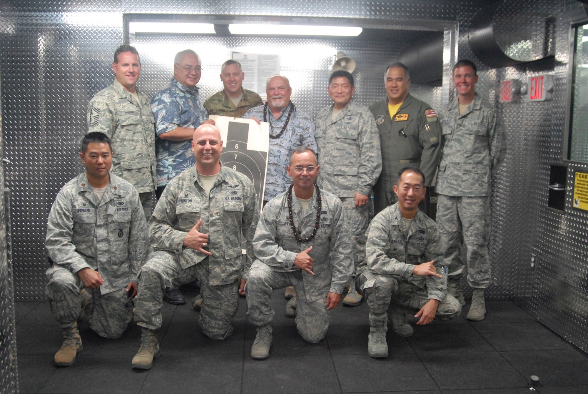 U.S. military service members participate in an ad hoc shooting competition after the blessing of the 154th Security Force Squadron Indoor Firing Range at Joint Base Pearl Harbor-Hickam, Hawaii, Aug. 8, 2015. Retired Brig. Gen. Edwin "Skip" Vincent, former commander of the Hawaii National Guard, took first place and returned Brig. Gen. Stan Osserman, also a former commander of the Hawaii Air National Guard, took second place in the competition. (U.S. Air National Guard photo by Airman 1st Class Robert Cabuco)