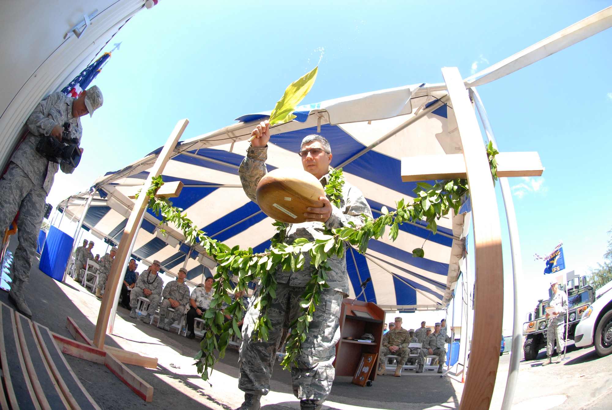 U.S. Air Force Chaplain Daniel Leatherman, 154th Wing Headquarters, performs a blessing at the 154th Security Forces Squadron (SFS) Indoor Firing Range on Joint Base Pearl Harbor-Hickam, Hawaii, Aug. 8, 2015. The Hawaiian tradition of unraveling of the maile lei, a native Hawaiian vine with shiny fragrant leaves, is similar to a typical ribbon cutting ceremony performed at the entrance of the new facility. (U.S. Air National Guard photo by Airman 1st Class Robert Cabuco)