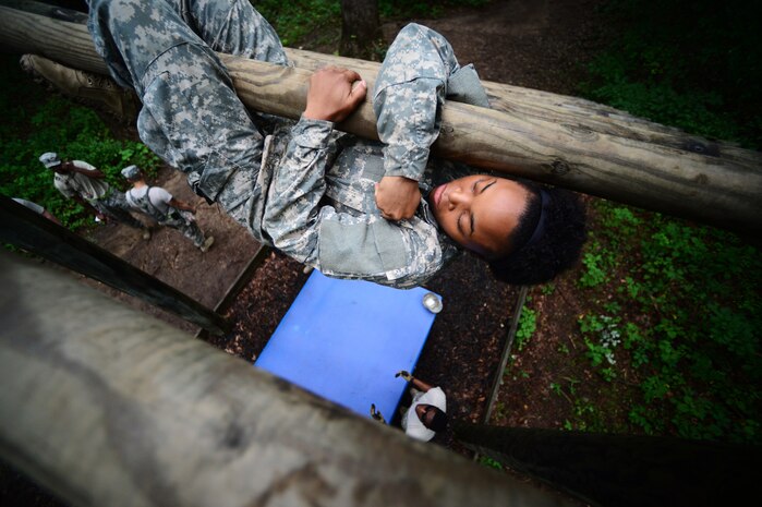 U.S. Army Spc. Mykia Ward, a Multimedia Illustrator, assigned to the 55th Signal Company (Combat Camera), traverses the "Weaver" obstacle during the 2015 3rd Annual Spc. Hilda I. Clayton Best Combat Camera (COMCAM) Competition at the Maryland Army National Guard Gunpowder Military Reservation Training Site, Glen Arm, Md., July 15, 2015. The obstacle course is conducted on day three of the Spc. Hilda I. Clayton Best COMCAM Competition, which is designed to build self-confidence and teamwork by taking members out of their comfort zones. The obstacle course is the sixth event, where teams of two compete throughout weeklong events that assess the technical and tactical skills of Visual Information Personnel. The competition is established in honor of the fallen Combat Camera Soldier, Spc. Hilda I. Clayton, who gave her life July 2, 2013, in Afghanistan as a part of Operation Enduring Freedom. (U.S. Air Force photo by Staff Sgt. Sam Weaver)
