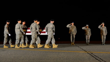 A U.S. Army carry team transfers the remains of 1st Sgt. Peter A. McKenna Jr., of Bristol, R.I., during a dignified transfer Aug. 10, 2015, at Dover Air Force Base, Del. McKenna was assigned to the 1st Battalion, 7th Special Forces Group, Eglin Air Force Base, Fla. (U.S. Air Force photo/Airman 1st Class William Johnson)