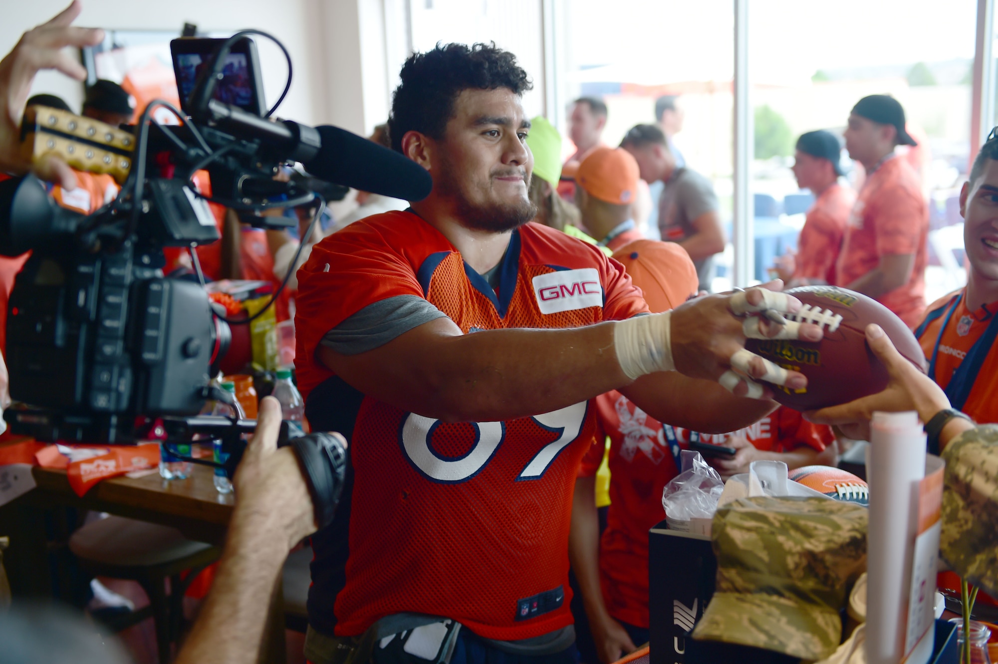 Sione Fua, Denver Broncos defensive lineman, signs autographs for military members after morning practice Aug. 7, 2015, at Denver Broncos Headquarters Facility at Dove Valley in Denver. The combine consisted of drills similar to the ones prospective National Football League players are expected to complete during the NFL combine held in Indianapolis before the NFL draft. All participants were also treated to a viewing of the Broncos’ Friday morning practice and a visit from Broncos players, as well as the head coach. (U.S. Air Force photo by Airman 1st Class Luke W. Nowakowski/Released)