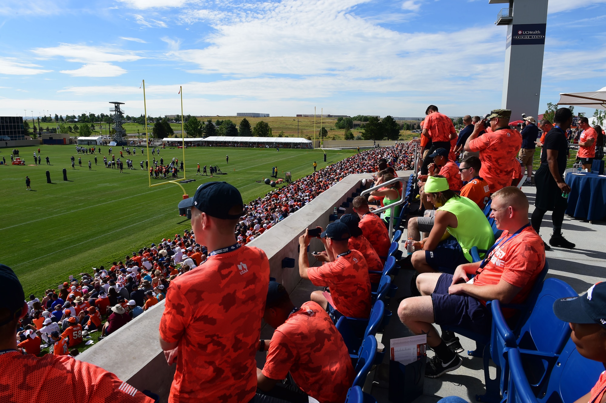 Military members watch the Denver Broncos training camp practice after participating in the military combine Aug. 7, 2015, at the Denver Broncos Headquarters Facility at Dove Valley in Denver.  The combine consisted of drills similar to the ones prospective National Football League players are expected to complete during the NFL combine held in Indianapolis before the NFL draft. All participants were also treated to a viewing of the Broncos’ Friday morning practice and a visit from Broncos’ players as well as the head coach. (U.S. Air Force photo by Airman 1st Class Luke W. Nowakowski/Released)