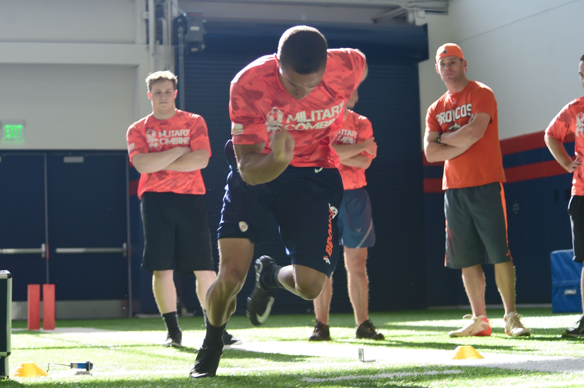 1st Lt. James MacAndrew, 2nd Space Warning Squadron Space Operations Center deputy commander, drives out of his stance during the 40-yard dash portion of the combine Aug. 7, 2015, at the Denver Broncos Headquarters Facility at Dove Valley in Denver. MacAndrew outperformed every competitor at the combine highlighted with a 4.7 second 40-yard dash and lifting 185 pounds on the bench press 28 times. His efforts won him tickets to a Broncos regular season home game along with field passes. (U.S. Air Force photo by Airman 1st Class Luke W. Nowakowski/Released)